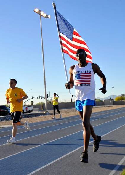 Senior Master Sgt. Leroy Ridgel, 56th Logistics Readiness Squadron acting chief, runs with the American flag April 4 during the Viking Challenge at Luke Air Force Base. Part of Team America, Ridgel, along with nine others of his team, completed the 10-hour long relay marathon to raise money for the Enlisted Scholarship Fund. Fourteen teams participated in the annual event. (U.S. Air Force photo/Senior Airman Marcy Copeland)