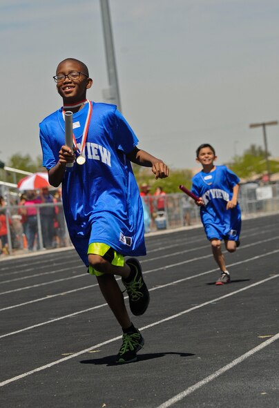 Steven participates in a relay race April 4 with team members from Sky View Elementary School during the Special Olympics event held at La Joya High School in Avondale. Special needs children from across the valley participated in track and field events at several high schools. (U.S. Air Force photo/Staff Sgt. Darlene Seltmann)