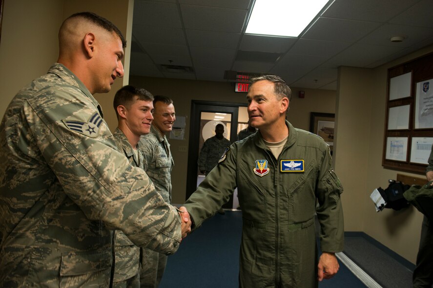 U.S. Air Force Maj. Gen. Jake Polumbo, Ninth Air Force commander, shakes hands with Senior Airman Thad Taylor, 15th Air Support Operations Squadron joint terminal attack controller, April 8, 2014, at Moody Air Force Base, Ga. Taylor was one of four Airmen who called airstrikes for Polumbo during a close air support training mission. (U.S. Air Force photo by Staff Sgt. Jamal D. Sutter/Released)   