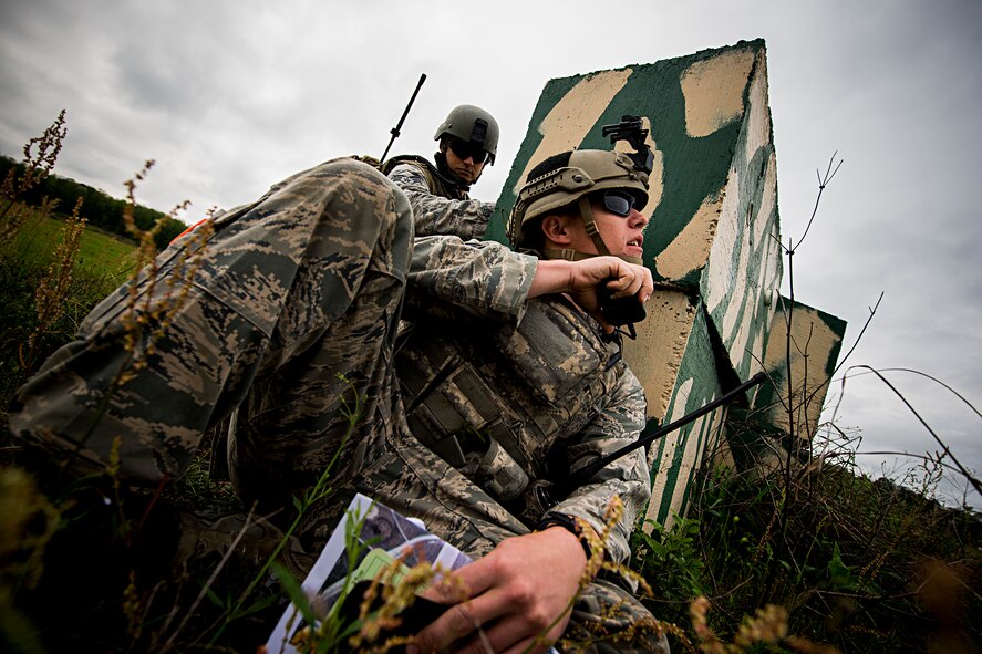 U.S. Air Force Senior Airman Jim Farrell, 15th Air Support Operations Squadron (ASOS) joint terminal attack controller (JTAC) out of Fort Stewart, Ga., seeks cover while calling an airstrike during a close air support training mission April 8, 2014, at Moody Air Force Base, Ga. During the scenario, Farrell and his wingman, Senior Airman Shawn Morgan, 15th ASOS JTAC, took enemy fire and needed assistance from friendly F-16 Fighting Falcons to eliminate the threat. (U.S. Air Force photo by Staff Sgt. Jamal D. Sutter/Released)  