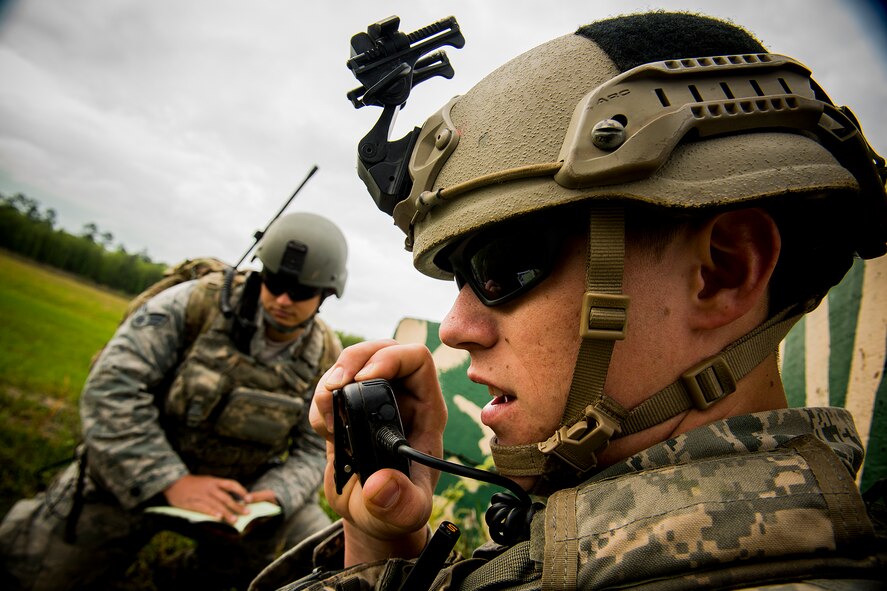 U.S. Air Force Senior Airman Jim Farrell, 15th Air Support Operations Squadron joint terminal attack controller, communicates with Capt. Mike Chebino, Ninth Air Force aide-da-camp and F-16 Fighting Falcon pilot, during a close air support training mission April 8, 2014, at Moody Air Force Base, Ga. Farrell is stationed out of Fort Stewart, Ga., and Chebino is stationed out of Shaw Air Force Base, S.C. (U.S. Air Force photo by Staff Sgt. Jamal D. Sutter/Released) 