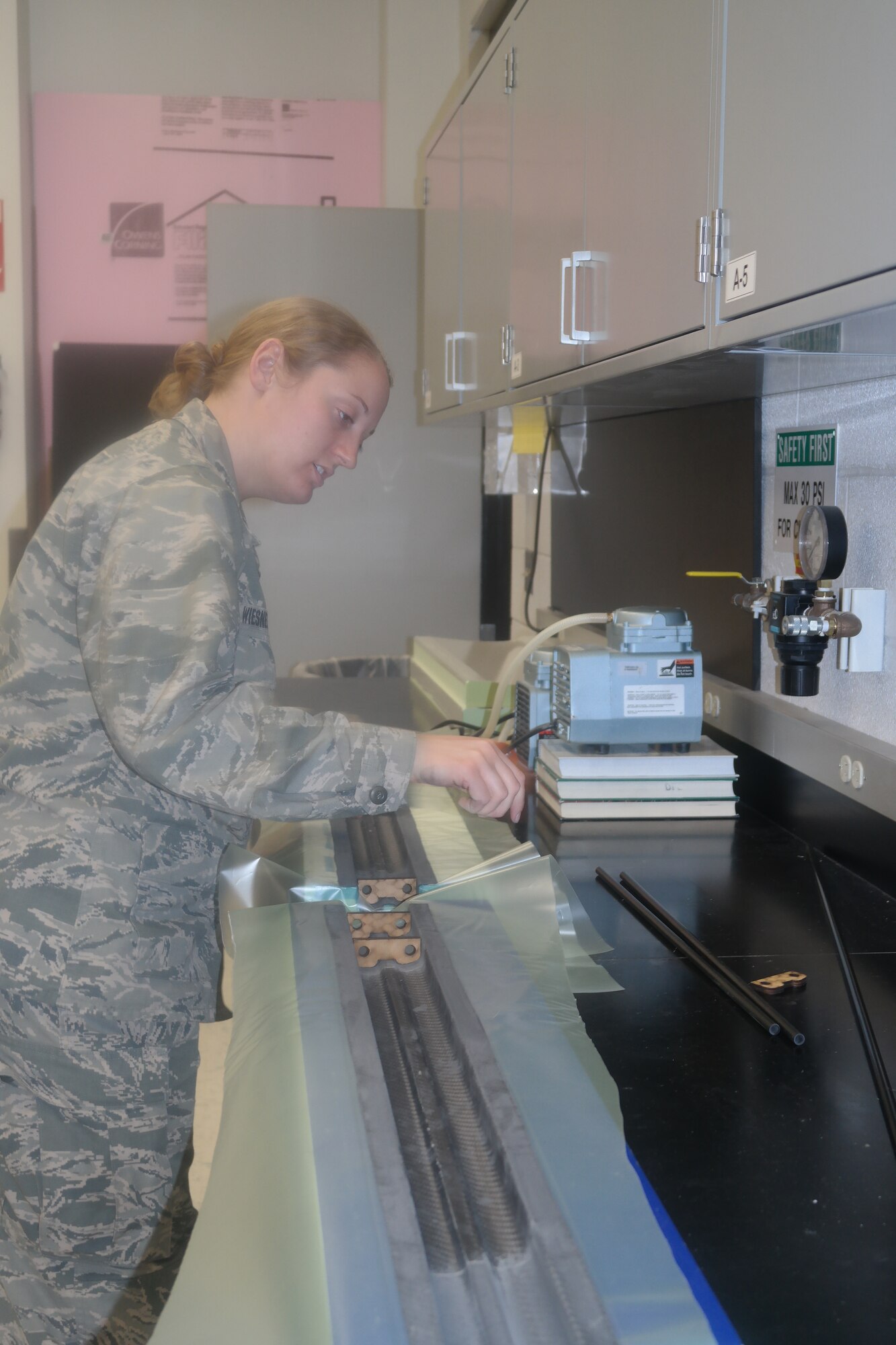Aeronautics major Cadet 1st Class Hannah Wiesneski works on the interior lining for an unmanned aerial vehicle she is building. here in April. The aircraft is scheduled to be used in three separate research projects. (Amy Gillentine/U.S. Air Force photo) 