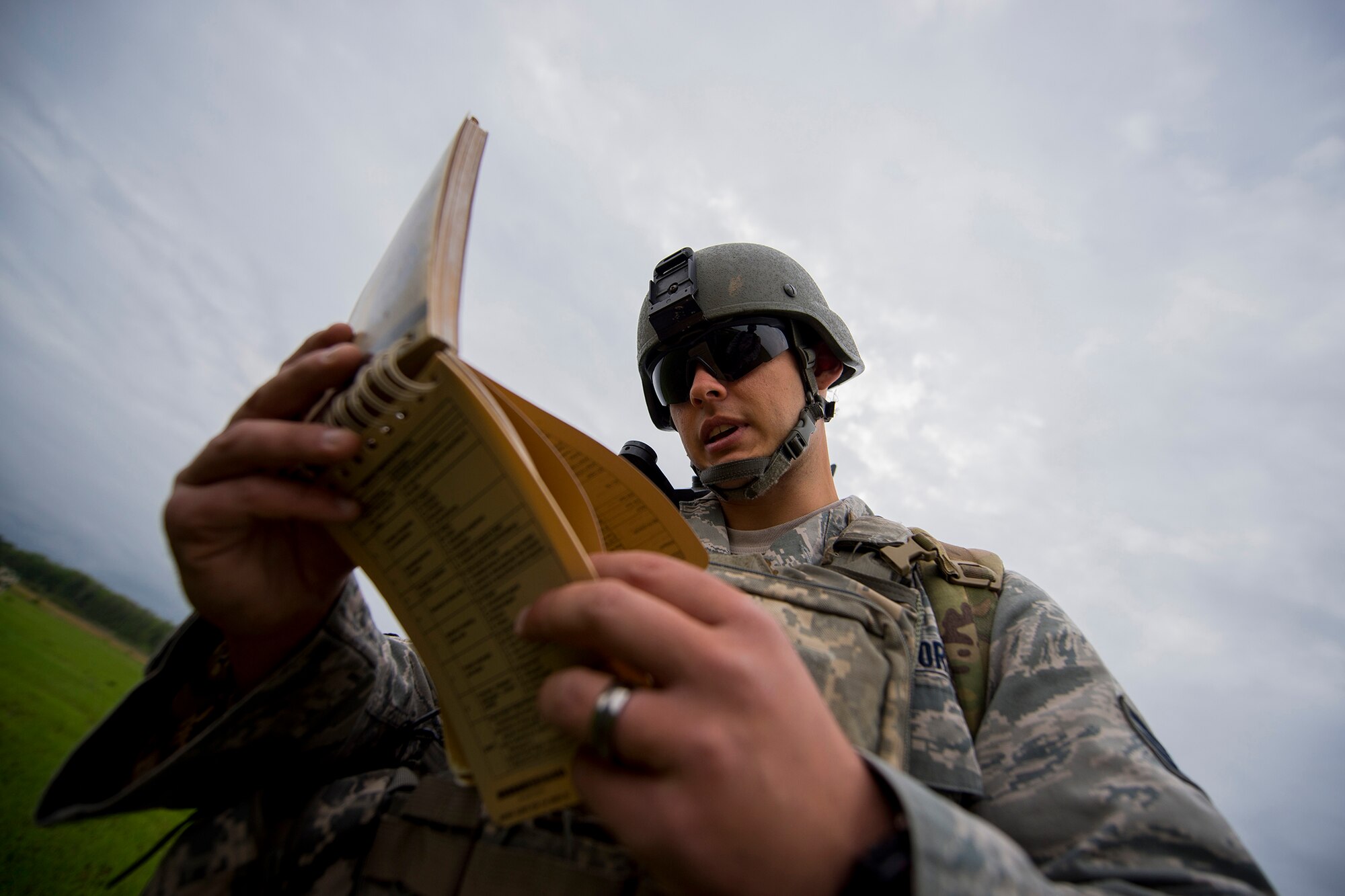 U.S. Air Force Senior Airman Shawn Morgan, 15th Air Support Operations Squadron joint terminal attack controller out of Fort Stewart, Ga., reviews a J-Fire manual during a close air support training mission April 8, 2014, at Moody Air Force Base, Ga. The J-Fire manual is a quick-reference guide for requesting airstrike requests and contains various information including calls for fire and data on weapons. (U.S. Air Force photo by Staff Sgt. Jamal D. Sutter/Released)  