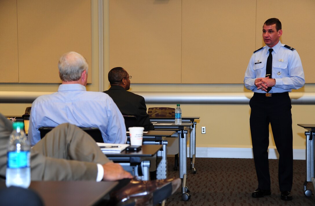 Col. Dean Hartman, 11th Mission Support Group commander, speaks to approximately 70 attendees at the Joint Base Andrew Small Business Summit, ranging from construction representatives to business owners, gather here April 9, 2014. to discuss bidding requirements for upcoming contracts. The briefings stressed the importance of small businesses and the desire for competition in contracts that give these businesses the opportunity to earn new revenue. (U.S. Air Force photo by Senior Airman Mariah Haddenham/ Released)