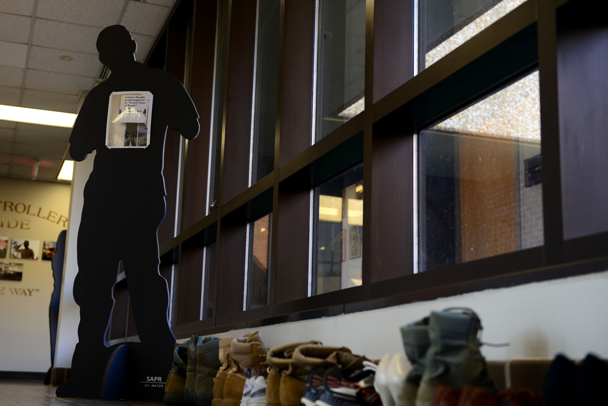 As part of Sexual Assault Awareness Month, the Sexual Assault Prevention and Response team displays shoes and boots representing each victim reported at Langley Air Force Base, Va. Along with the shoes and boots, the SAPR team placed “traveling silhouettes” to raise awareness about sexual assault. (U.S. Air Force photo by Airman 1st Class Kimberly Nagle/Released)