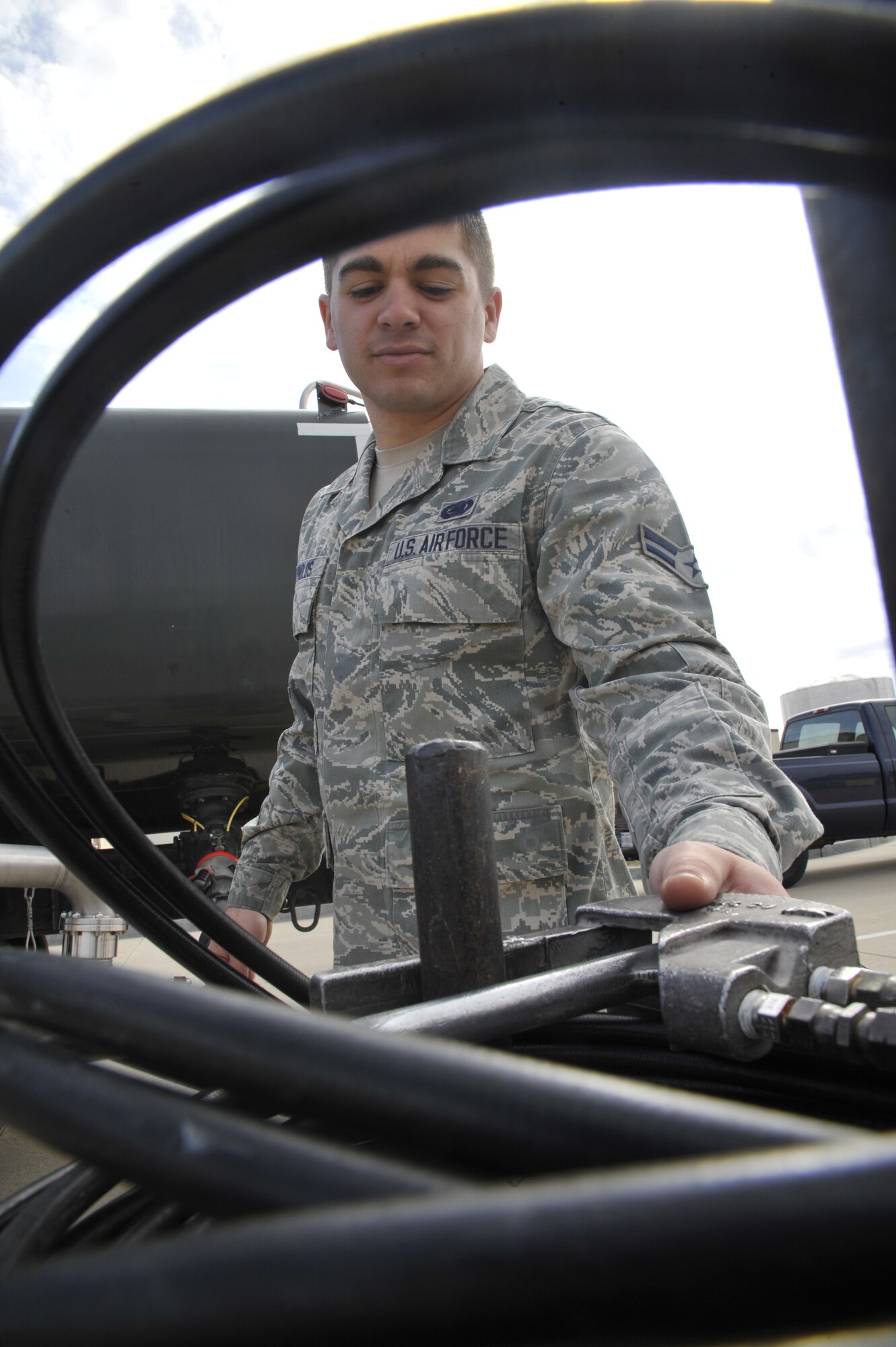 U.S. Air Force Airman 1st Class Joshua Reynolds, 509th Logistics Readiness Squadron fuels distribution technician, puts down a hose reel at Whiteman Air Force Base, Mo. April 1, 2014.  The reel is used to “run “the hose back into the R11 truck for safe and security purposes. (U.S. Air Force photo by Airman 1st Class Keenan Berry/Released)  