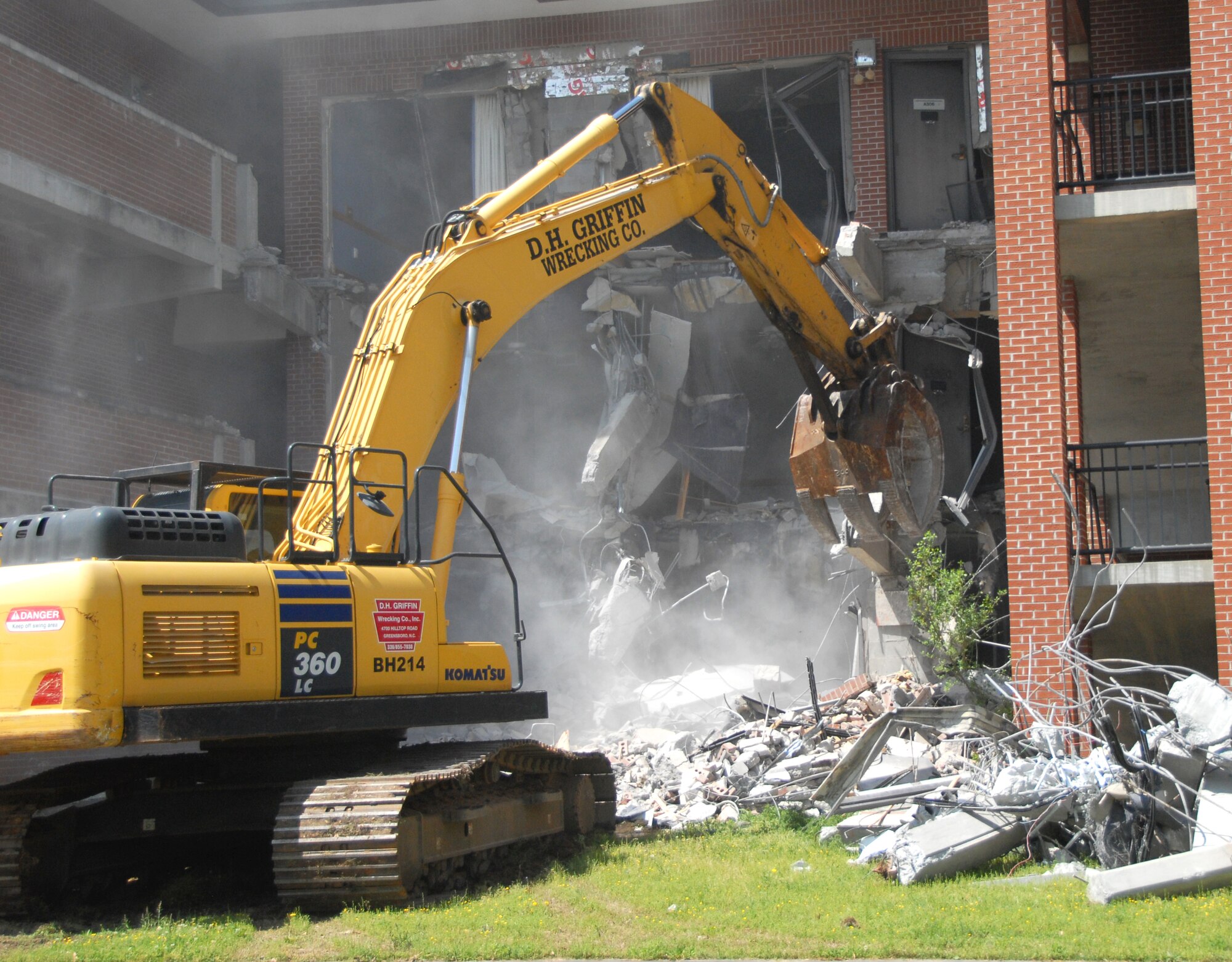 The 78th Civil Engineer Group begins demolition on a building formerly used as an Airman dormitory.  Destroying the building was said to be more cost-effective than renovation efforts. (U.S. Air Force photo by Misuzu Allen)