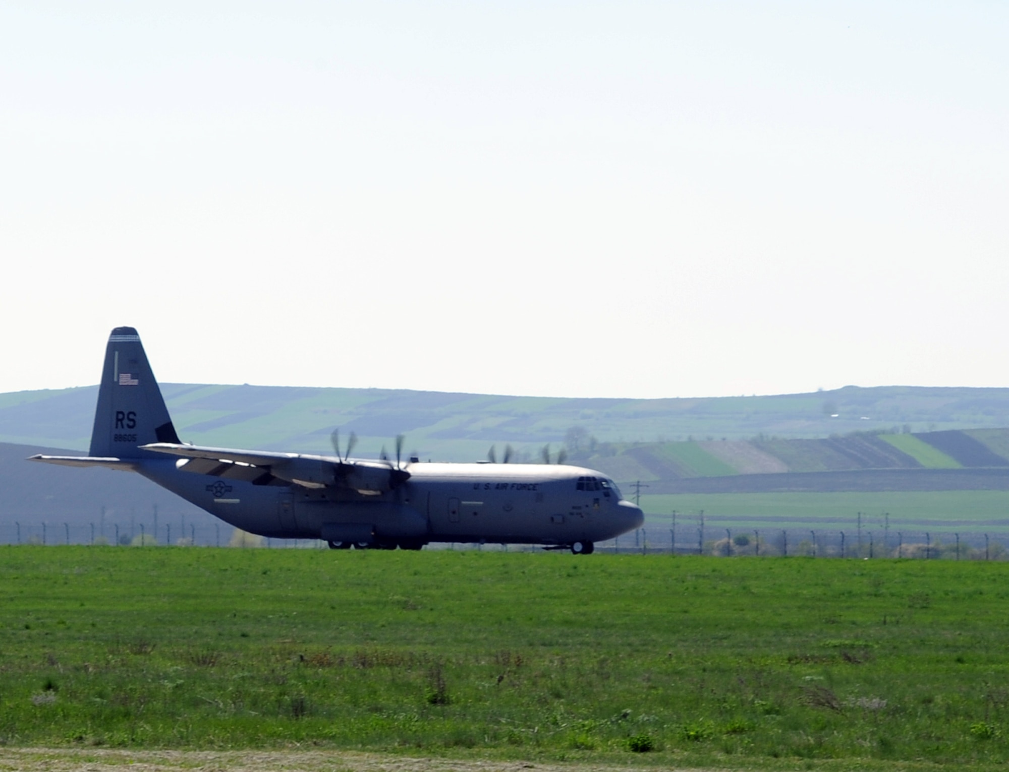 Airmen from the 31st Fighter Wing at Aviano Air Base, Italy, arrive on a C-130J Super Hercules at Campia Turzii, Romania, April 8, 2014, to participate in an F-16 Fighting Falcon training exercise with the Romania air force. Dacian Viper 2014 aims to enhance interoperability and readiness through combined air operations, including air-to-air, air-to-ground and joint tactical air controller training. (U.S. Air Force photo/Staff Sgt. R.J. Biermann)