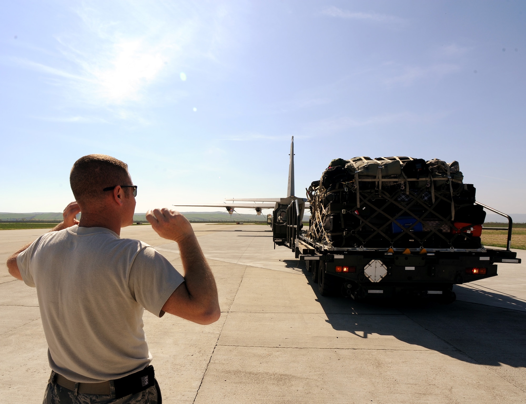 Master Sgt. Francis Watermolen, 31st Logistics Readiness Squadron air operations office section chief, directs a vehicle operator after unloading cargo from a C-130J Super Hercules, April 8, 2014, at Campia Turzii, Romania. From April 10-17, the U.S. and Romanian air forces will conduct a bilateral training exercise here – Dacian Viper 2014. (U.S. Air Force photo/Staff Sgt. R.J. Biermann)