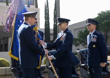 Gen. Robin Rand, left, commander of Air Education and Training Command, presents the unit guidon to Maj. Gen. Bart Iddins, center, during the 59th Medical Wing’s change of command ceremony April 10 at the Wilford Hall Ambulatory Surgical Center, Joint Base San Antonio-Lackland, Texas. Iddins, who was previously Command Surgeon, Headquarters Air Mobility Command, Scott Air Force Base, Ill., replaces a retiring Maj. Gen. Byron Hepburn, right, who led the 59th MDW through its integration with Army medical services as part of the new San Antonio Military Health System. The 59th MDW is comprised of more than 6,000 personnel who provide medical services to nearly 240,000 beneficiaries in the San Antonio metropolitan area. (U.S. Air Force photo/Staff Sgt. Kevin Iinuma)