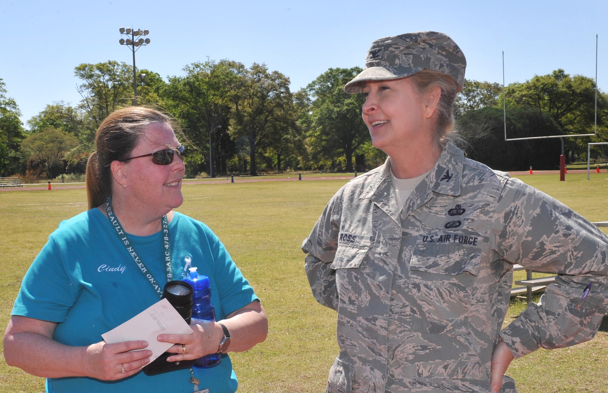 Cindy Graver, base sexual assault response coordinator, chats with Col. Patricia Ross, 78th Air Base Wing vice commander, during the “Walk a Mile in Their Shoes” event Thursday at the outdoor track on base. (U.S. Air Force photo by Tommie Horton)