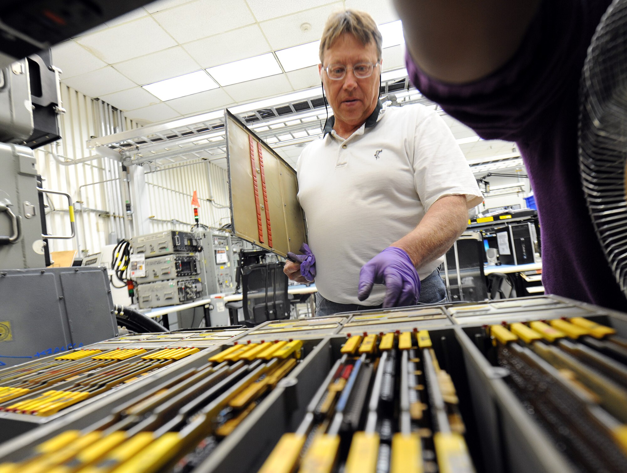 Ernie Wood, electronics mechanic, tests the functionality of a complex F-15 flight control computer. (U.S. Air Force photo by Tommie Horton)