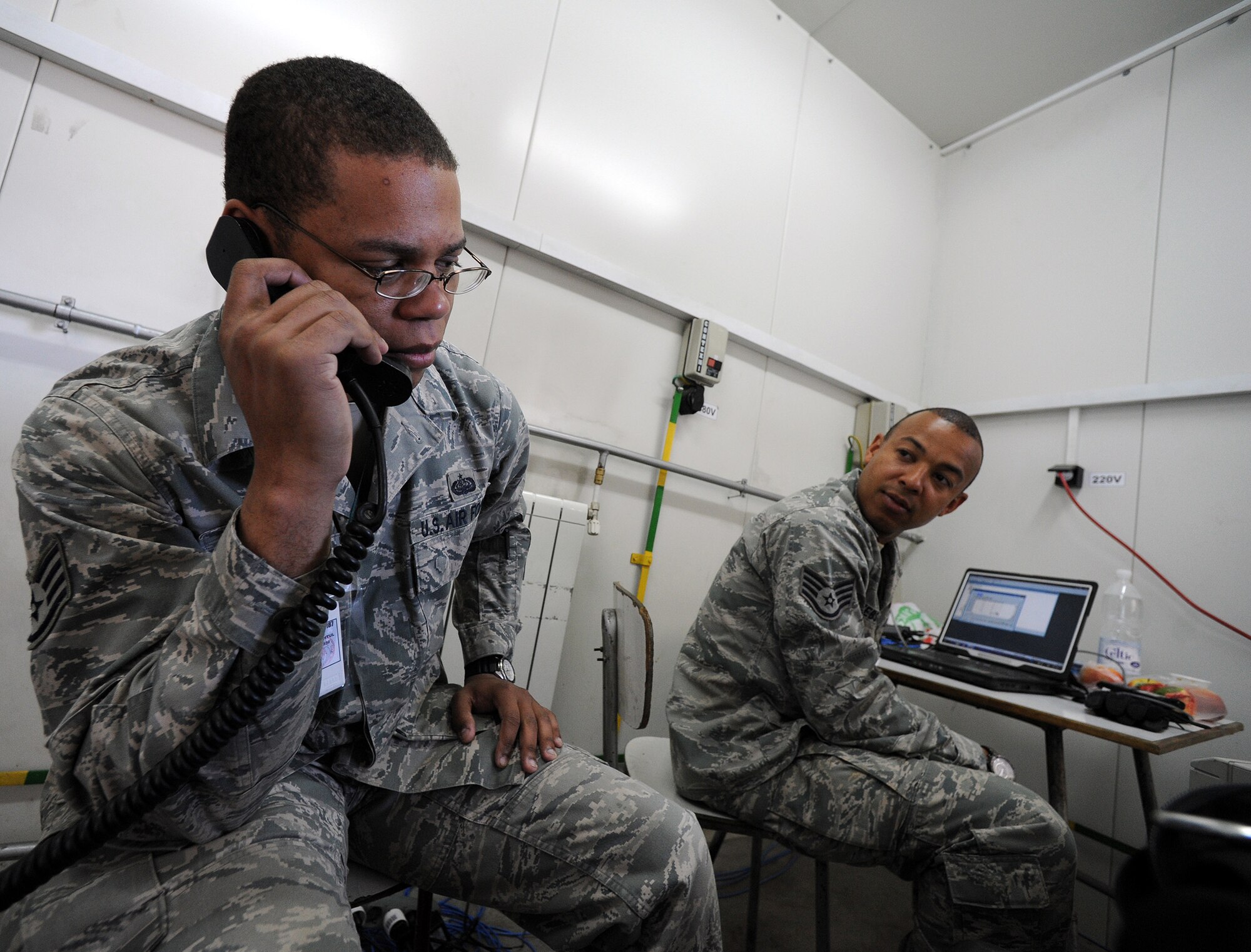 Staff Sgt. Vincent Hopson, 1st Combat Communication Squadron rapid deployable radio frequency transmissions system supervisor, tests a radio system as Staff Sgt. Jason Webster, 1st CBCS RF transmissions supervisor, listens in April 8, 2014, at Campia Turzii, Romania. The 1st CBCS is assigned to the 435th Air Ground Operations Wing at Ramstein Air Base, Germany. (U.S. Air Force photo/Staff Sgt. R.J. Biermann)
