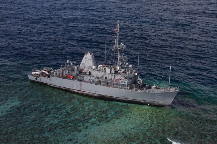 The USS Guardian (MCM 5) is seen after the pounding of ocean waves pushed it onto Tubbataha Reef. Operations to safely recover the ship while minimizing environmental effects were conducted in close cooperation with allied Philippines Coast Guard and Navy. (U.S. Navy photo/Petty Officer 3rd class Geoffrey Trudell)