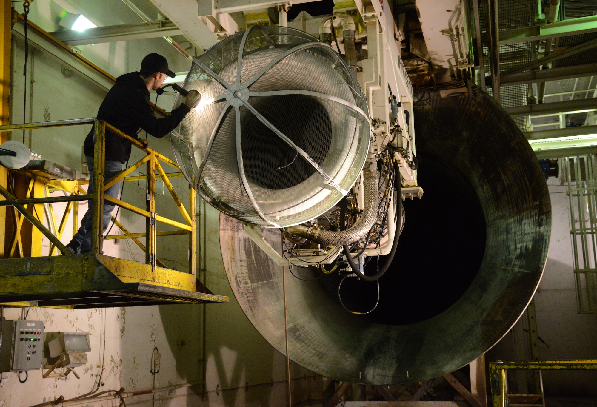 Brian McDaniel, a jet engine inspector, checks for leaks in an F118-100 engine for a B-2 Stealth Bomber in the Engine Test Cell with the 547th Propulsion Maintenance Squadron. (Air Force photo by Kelly White)