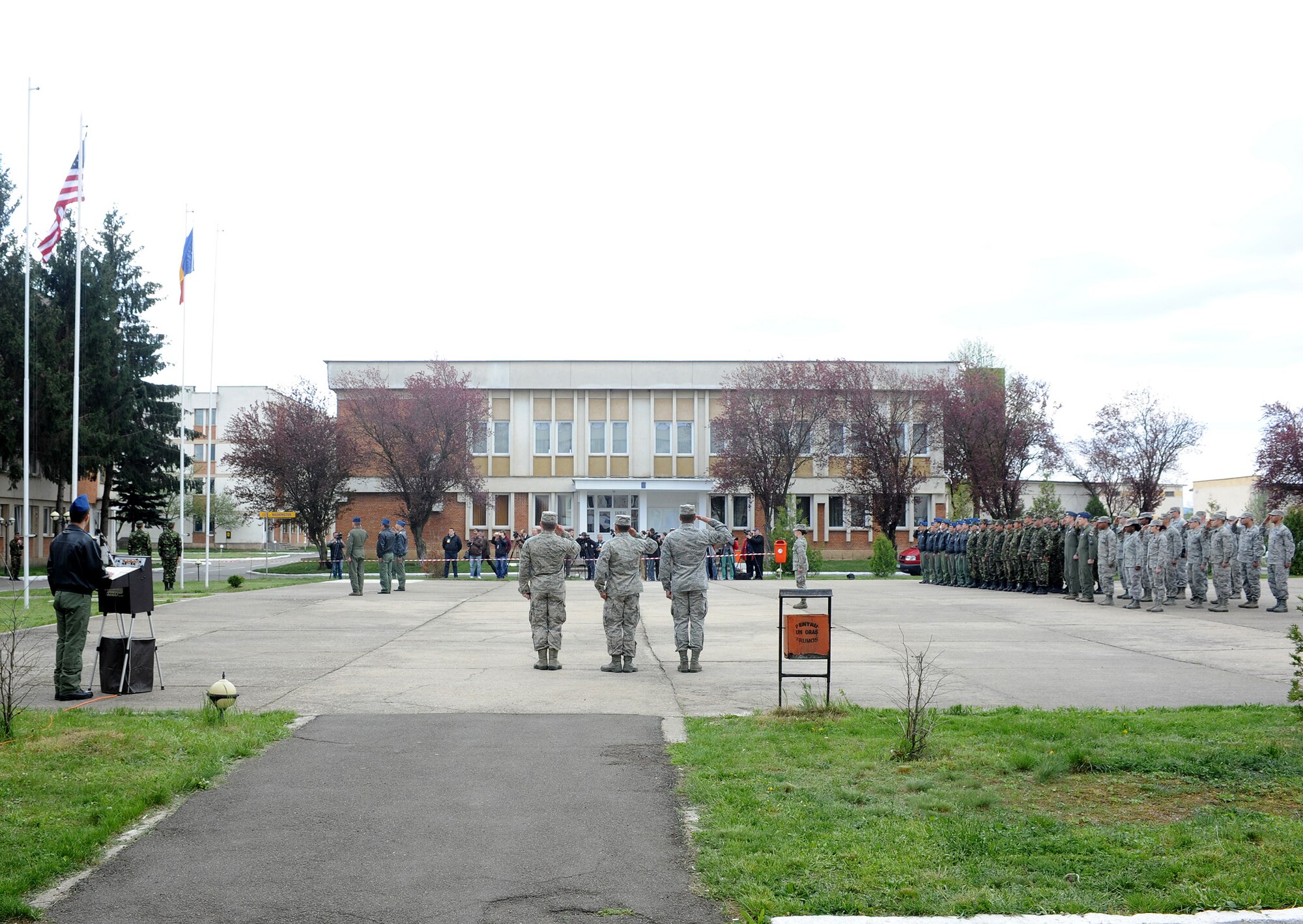 U.S. and Romanian Airmen render a salute as the Romanian flag is raised during the opening ceremony for exercise Dacian Viper 2014 at Campia Turzii, Romania, April 10, 2014. The exercise is the latest example of military cooperation between the U.S. and Romanian air forces. (U.S. Air Force photo/Staff Sgt. R.J. Biermann)