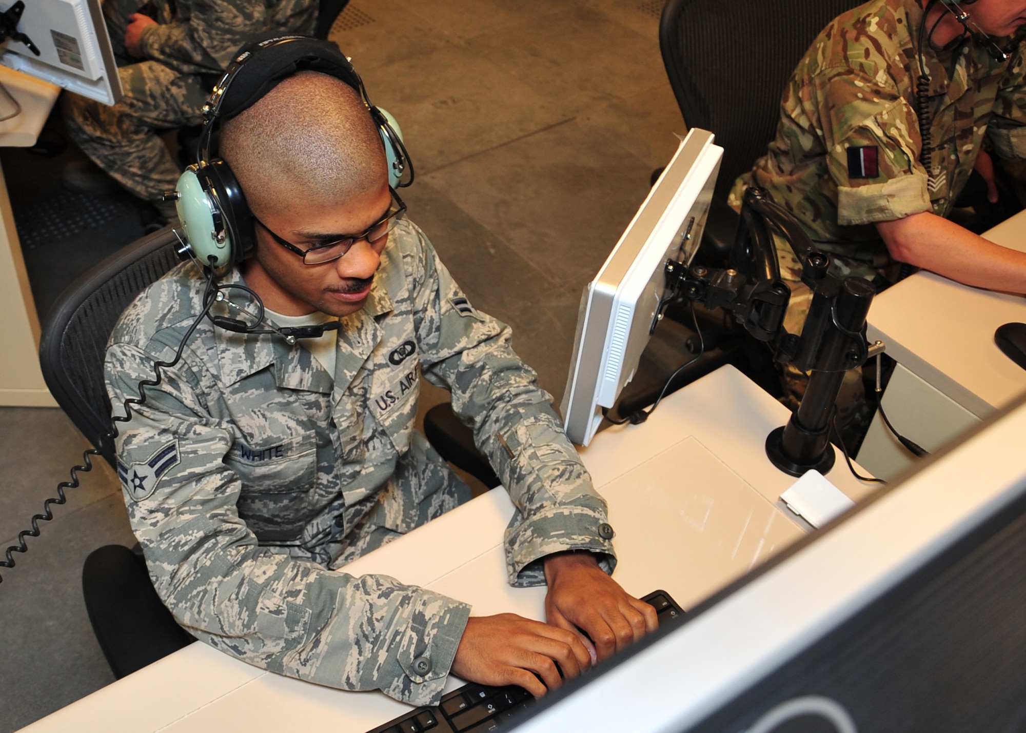 U.S. Air Force Airman 1st Class Charles White, 727 Expeditionary Air Control Squadron surveillance technician, becomes familiar with the workstations at the new Battlespace Command and Control Center Theater, or BC3-T, at an undisclosed location in Southwest Asia, April 9, 2014. The new BC3-T is scheduled to be fully operational July of this year. White is deployed from the 729th Air Control Squadron at Hill Air Force Base, Utah, and is a native of Longview, Texas. (U.S. Air Force photo by Staff Sgt. Michael Means/Released)