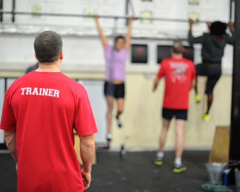 U. S. Air Force Tech. Sgt. Mark Salzman, a 372nd Training Squadron Detachment 17 F-16 avionics instructor and level one certified trainer, observes participants in the Combat Fitness Center fundamentals class April 8, 2014, at Spangdahlem Air Base, Germany. The Combat Fitness Center staff offer the class to military members and their dependents. (U. S. Air Force photo by Airman 1st Class Dylan Nuckolls/Released)