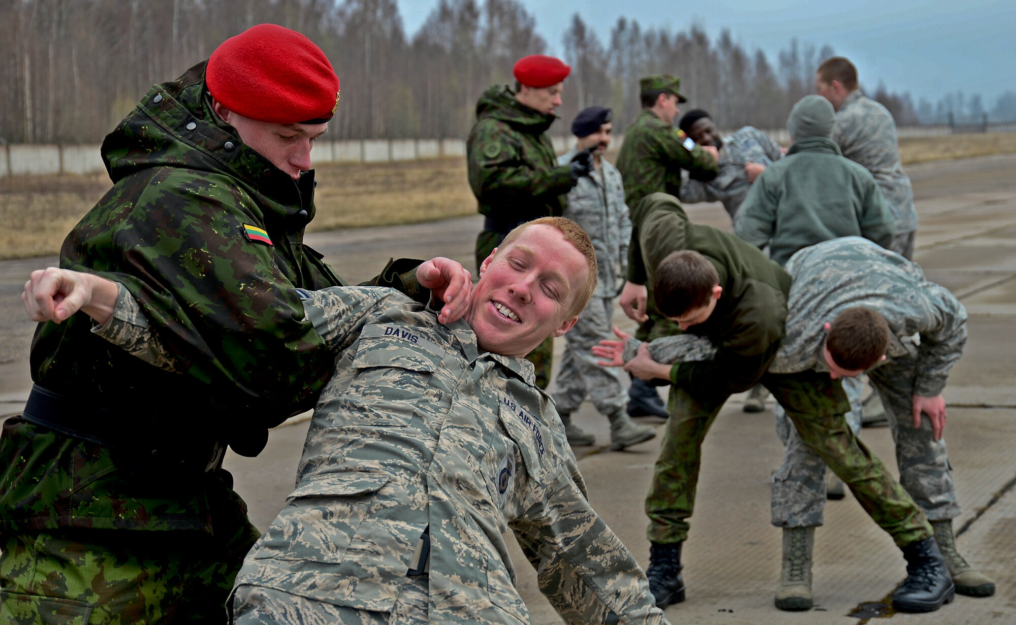 Security Forces members assigned to the 48th Air Expeditionary Group and Lithuanian air force military police members practice the use of, mechanical advantage control hold techniques during combined force training with Lithuanian air force military police at Šiauliai Air Base, Lithuania, April 8, 2014, to build partnerships and enhance cooperation. These techniques are a non-lethal use of force tool employed by security forces to control or subdue a subject until the situation has been de-escalated.  (U.S. Air Force photo by Airman 1st Class Dana J. Butler/Released)  