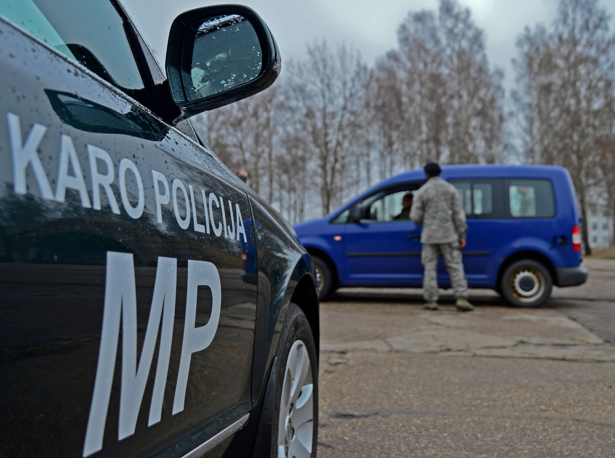 Airman 1st Class Samuel Gray, 48th Air Expeditionary Group response force member, performs a routine traffic stop scenario during combined force training with the Lithuanian air force military police at Šiauliai Air Base, Lithuania, April 8, 2014. Security Forces members assigned to the 48th Air Expeditionary Group recently conducted the training to build partnerships and enhance cooperation; the two nations exchanged tactics, techniques and procedures for law enforcement operations. (U.S. Air Force photo by Airman 1st Class Dana J. Butler/Released)  