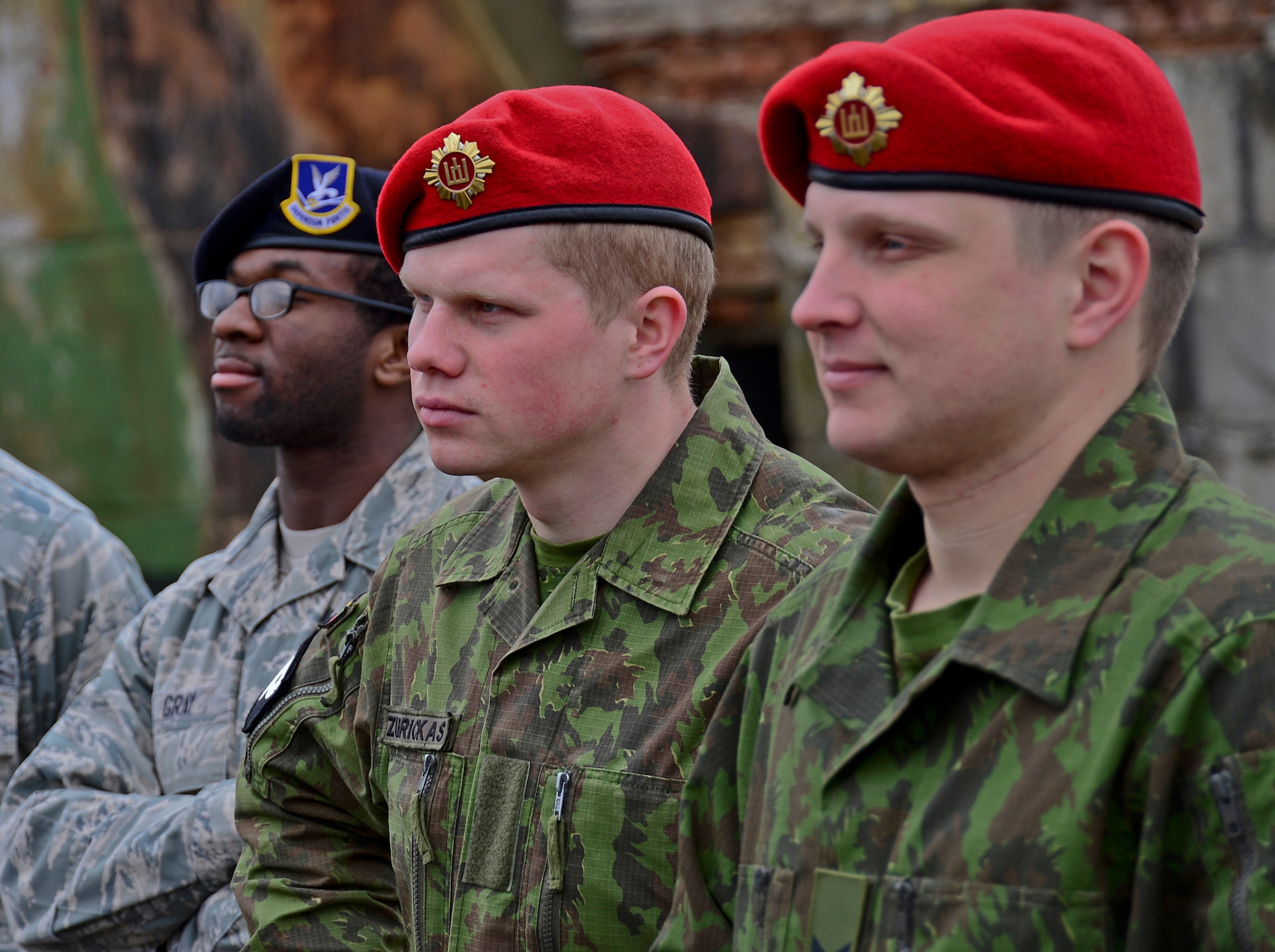 Lithuanian air force military police members and U.S. Air Force Security Forces Airmen listen to a briefing during combined force training with Lithuanian air force military police at Šiauliai Air Base, Lithuania, April 8, 2014. Security Forces members assigned to the 48th Air Expeditionary Group recently conducted the training to build partnerships and enhance cooperation; the two nations exchanged tactics, techniques and procedures for law enforcement operations. (U.S. Air Force photo by Airman 1st Class Dana J. Butler/Released)  