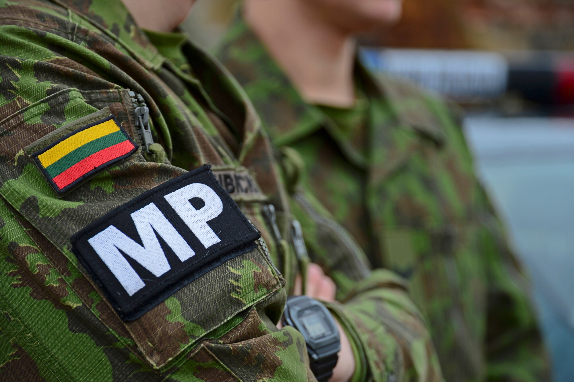 A Lithuanian air force military police member watches as U.S. Air Force security forces Airmen perform a routine traffic stop scenario during combined force training with the Lithuanian air force military police at Šiauliai Air Base, Lithuania, April 8, 2014. Security Forces members assigned to the 48th Air Expeditionary Group recently conducted the training to build partnerships and enhance cooperation; the two nations exchanged tactics, techniques and procedures for law enforcement operations. (U.S. Air Force photo by Airman 1st Class Dana J. Butler/Released)  