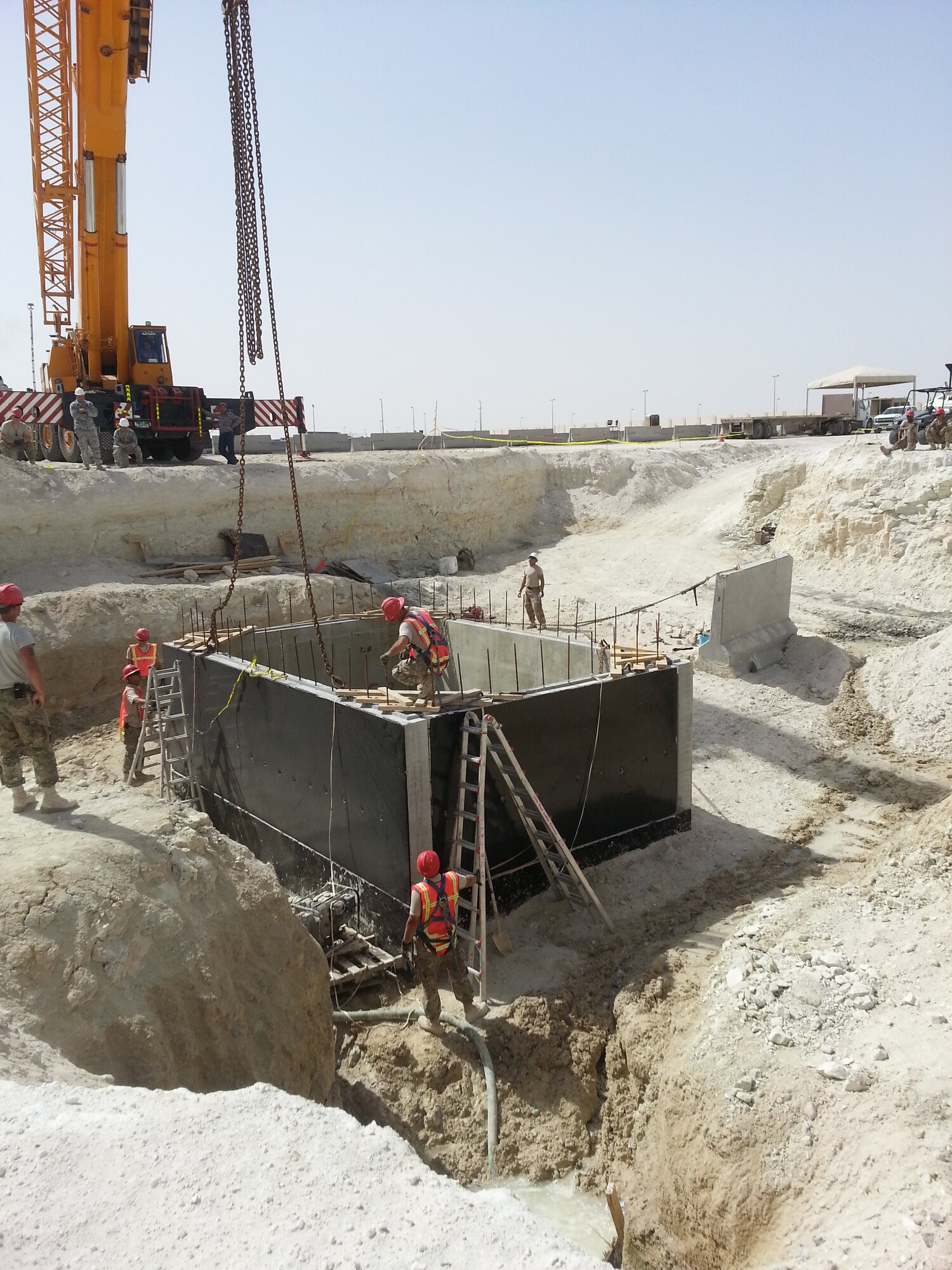 Members of the 557th Expeditionary Prime Base Engineer Emergency Force Squadron lift station crew, install a wall for a new sewage lift station. (Courtesy photo by Capt. Amy Peabody)