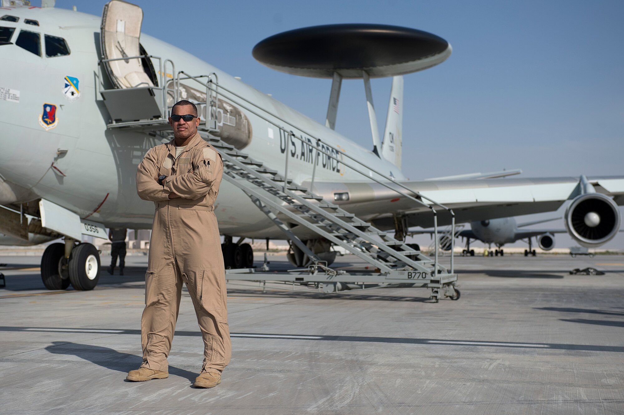 Air Force Lt. Col. (Dr.) Robert Craig-Gray, 380th Expeditionary Medical Group deputy commander and chief of aerospace medicine, poses for a photo in front of an E-3 Sentry after exceeding 1,000 flying hours, after a combat sortie flown in support of Afghanistan Presidential Elections, April 5, 2014, at an undisclosed location in Southwest Asia. He reached this feat during his 301st sortie. (U.S. Air Force photo by Tech. Sgt. Jason Robertson/Released)
