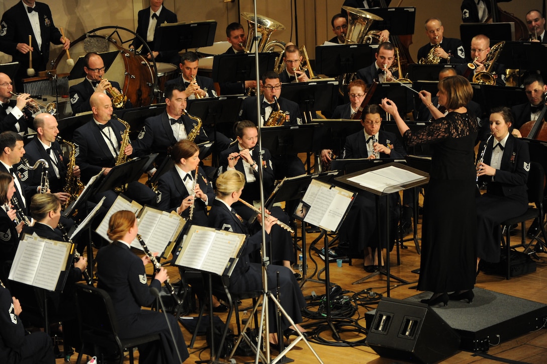 Dr. Mary Schneider conducts “Danzón No. 2 “during The U.S. Air Force Band’s Concert Band at Eastern Michigan University in Ypsilanti Mich., April 9, 2014. Schneider is the university director of bands and an associate professor of music. Throughout the Band’s 2014 Spring Concert Tour, guest conductors and instrumental and vocal students shared the stage with the bandsmen showcasing their musical talents. (U.S. Air Force photo/Master Sgt. Tammie Moore)