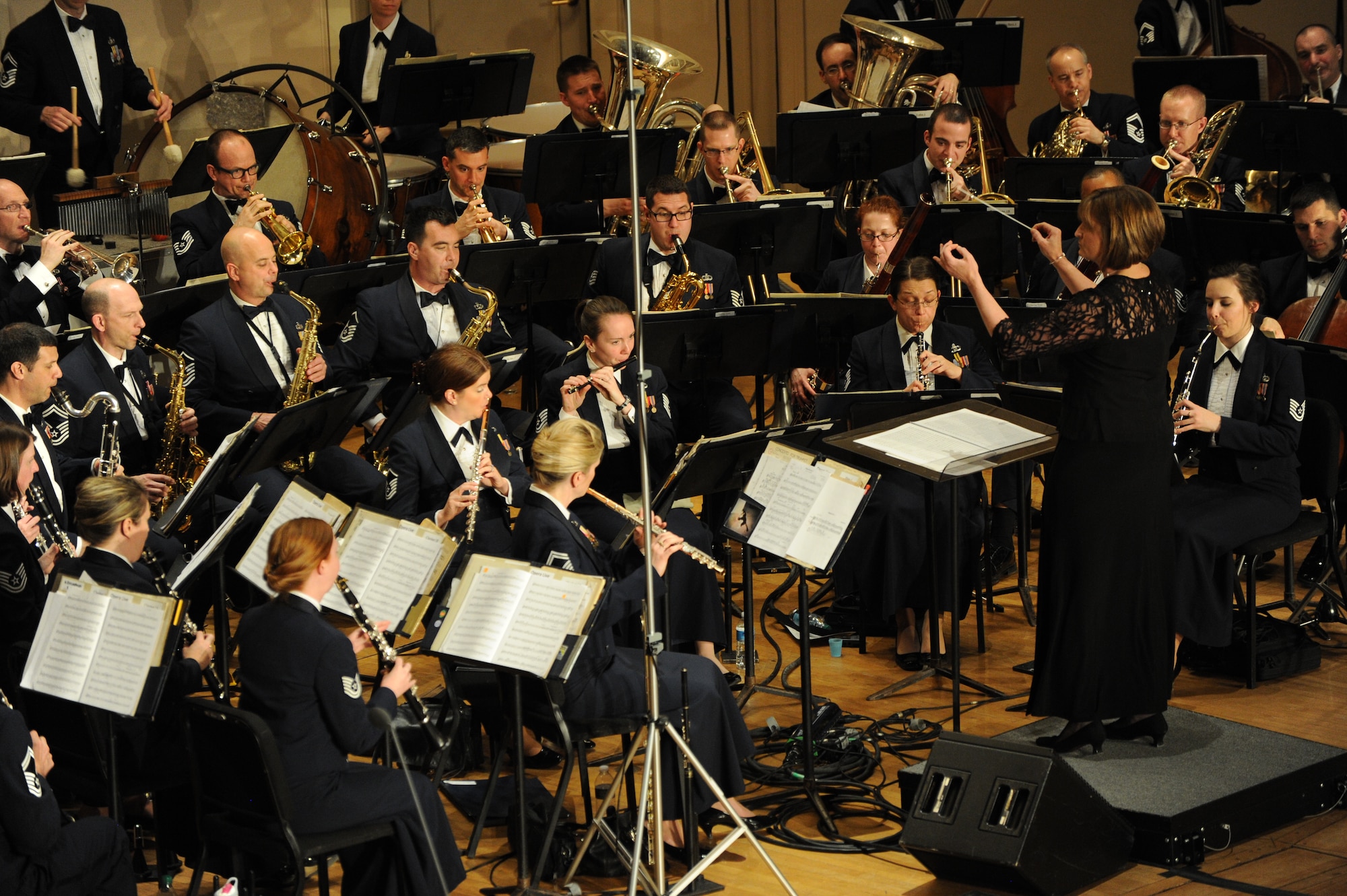 Dr. Mary Schneider conducts “Danzón No. 2 “during The U.S. Air Force Band’s Concert Band at Eastern Michigan University in Ypsilanti Mich., April 9, 2014. Schneider is the university director of bands and an associate professor of music. Throughout the Band’s 2014 Spring Concert Tour, guest conductors and instrumental and vocal students shared the stage with the bandsmen showcasing their musical talents. (U.S. Air Force photo/Master Sgt. Tammie Moore)