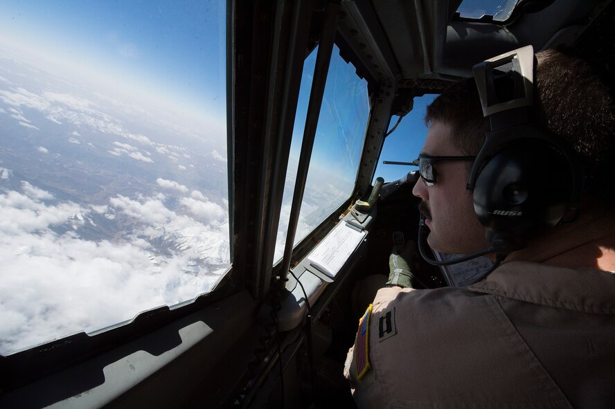 U.S. Air Force Capt. Christopher K. Jordan, 968th Expeditionary Airborne Air Control Squadron E-3/B Sentry pilot, scans the horizon while flying a combat sortie in support of Afghanistan Presidential Elections, April 4, 2014, over Afghanistan. The crew of the E-3/B flew the sortie marking the 968th EAACS's 4,000th combat sortie, since March 2007, when the squadron began combat operations in support of Operation Iraqi Freedom, Operation New Dawn and Operation Enduring Freedom. Jordan, a Little River, Kan. native, is deployed from the 963rd Airborne Air Control Squadron, Tinker Air Force Base, Ok. (U.S. Air Force photo by Tech. Sgt. Jason Robertson/Released)