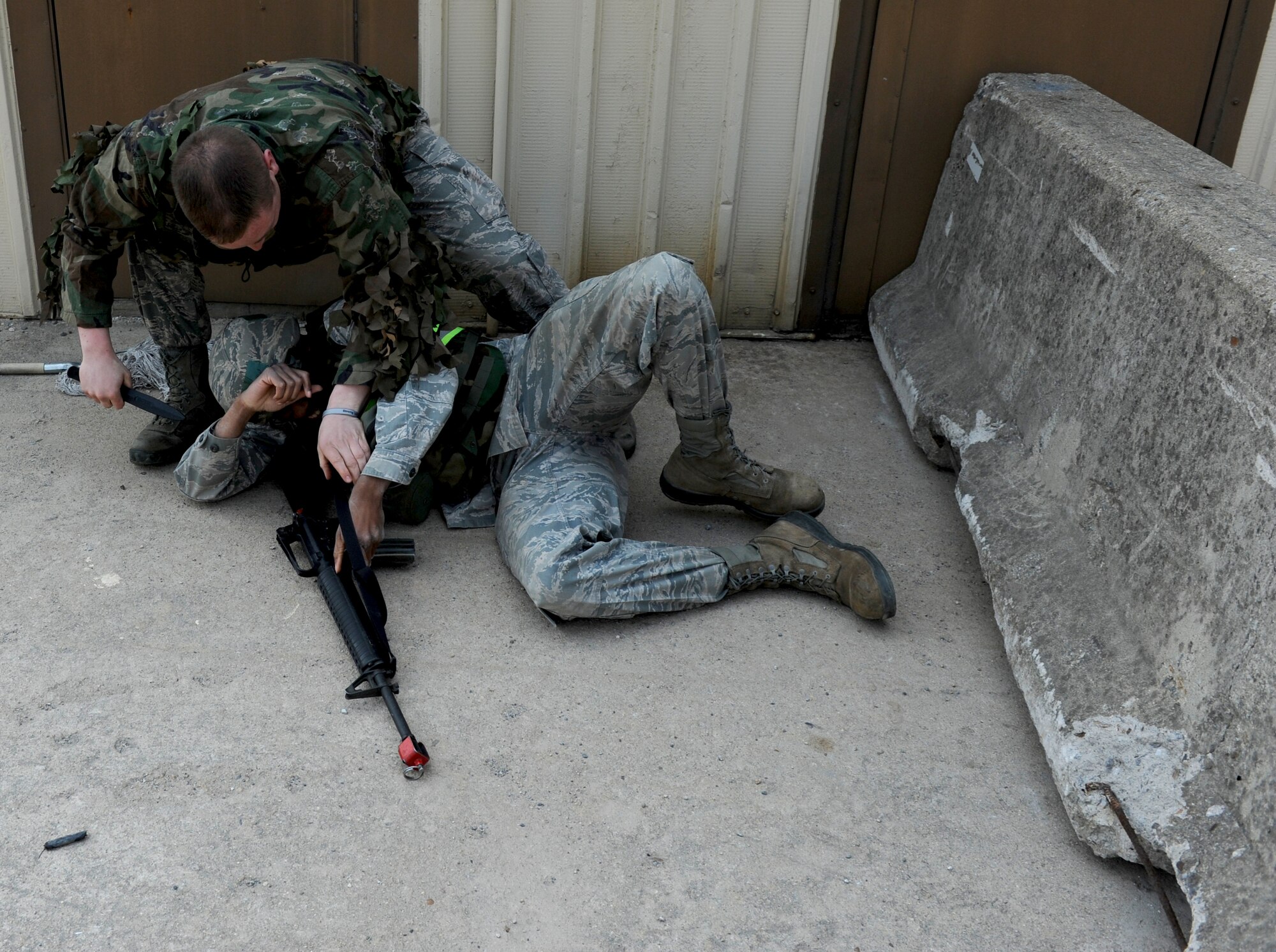 Staff Sgt. Troy Reed, 8th Security Forces Squadron noncommissioned officer in charge of training and training role player, sneaks up on and ‘attacks’ Senior Airman Michael Todd, 8th Civil Engineer Squadron pavements and heavy equipment journeyman, during a training exercise at Kunsan Air Base, Republic of Korea, Apr. 10, 2014. The 8th SFS trained the Red Devils on communication tactics, apprehending suspects and manning defensive positions. (U.S. Air Force photo by Staff Sgt. Jessica Haas/Released)