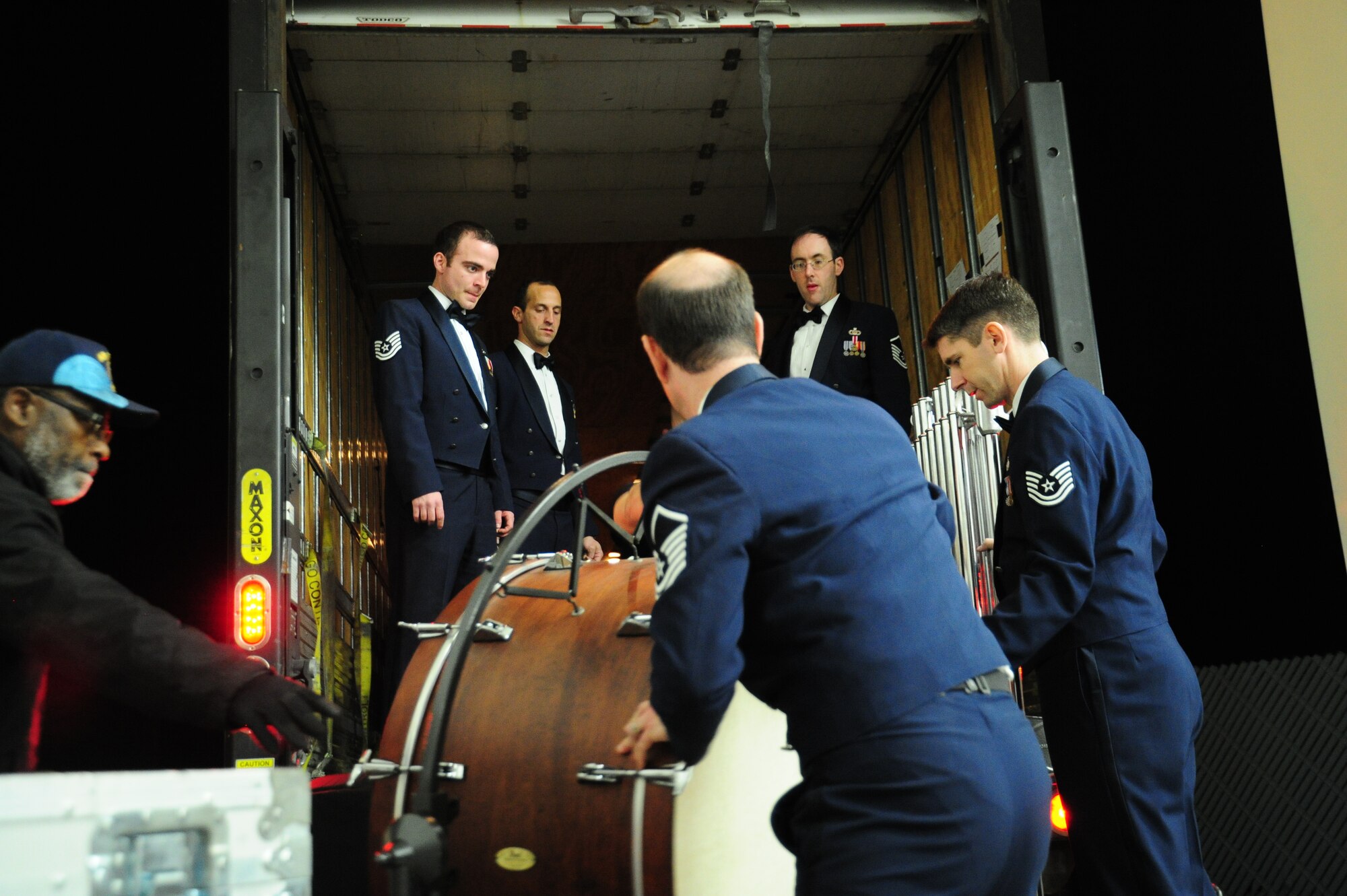 Members of The U. S. Air Force Band quickly store their instruments and equipment on a moving truck after their performance at Monroe County Community College in Monroe, Mich., April 8, 2014. This is done after every performance, as part of the Band’s 2014 Spring Tour across Illinois, Indiana and Michigan. (U. S. Air Force photo/Airman 1st Class Joshua R. M. Dewberry)