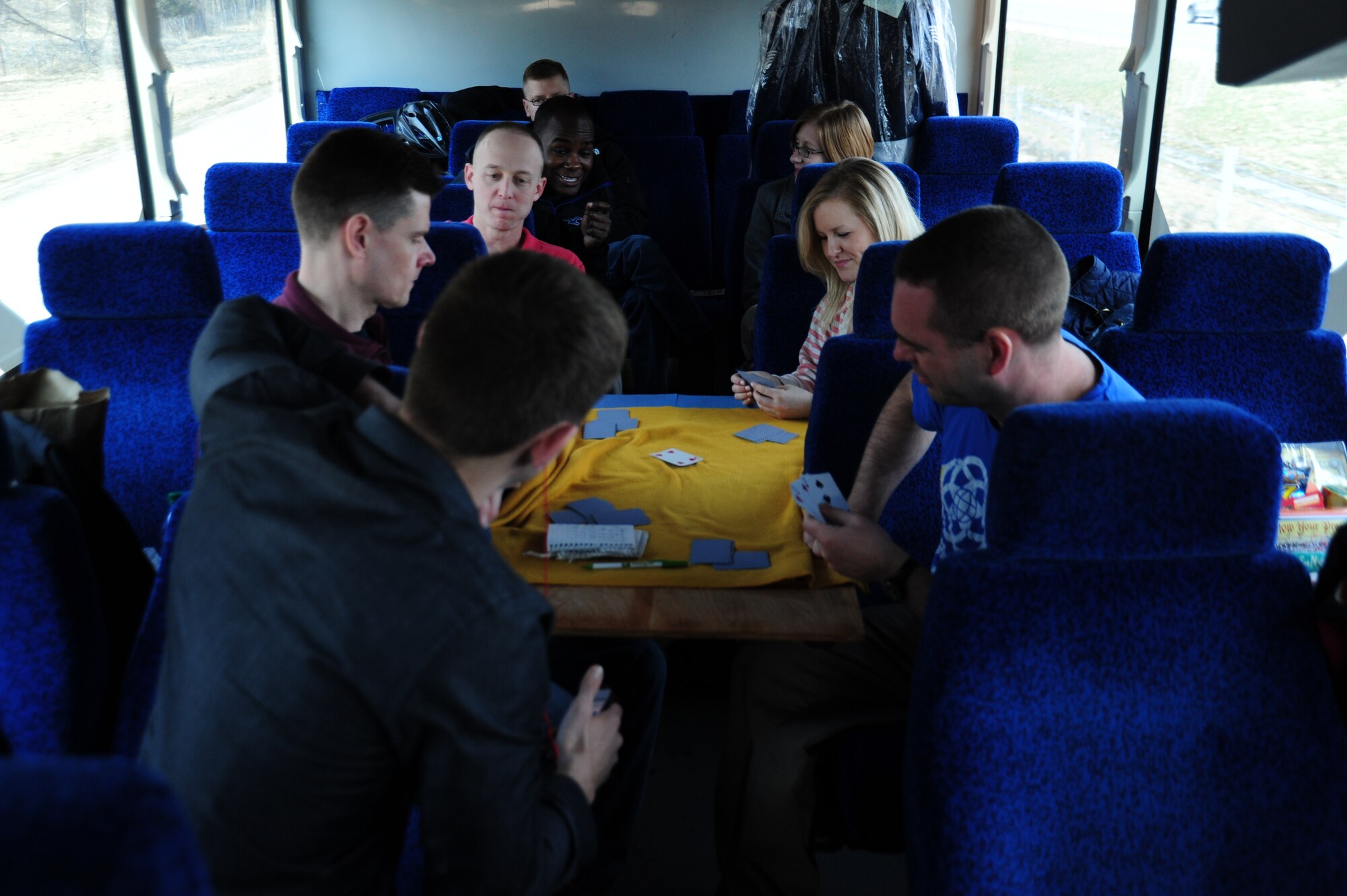 Members of The U. S. Air Force Band’s Singing Sergeants play a game of cards while en route to their next destination during their 2014 Spring Tour across Illinois, Indiana and Michigan, April 8, 2014. The Band is on the road every day of the tour with driving time ranging from 30 minutes to several hours performing at different sites each day. (U. S. Air Force photo/Airman 1st Class Joshua R. M. Dewberry)