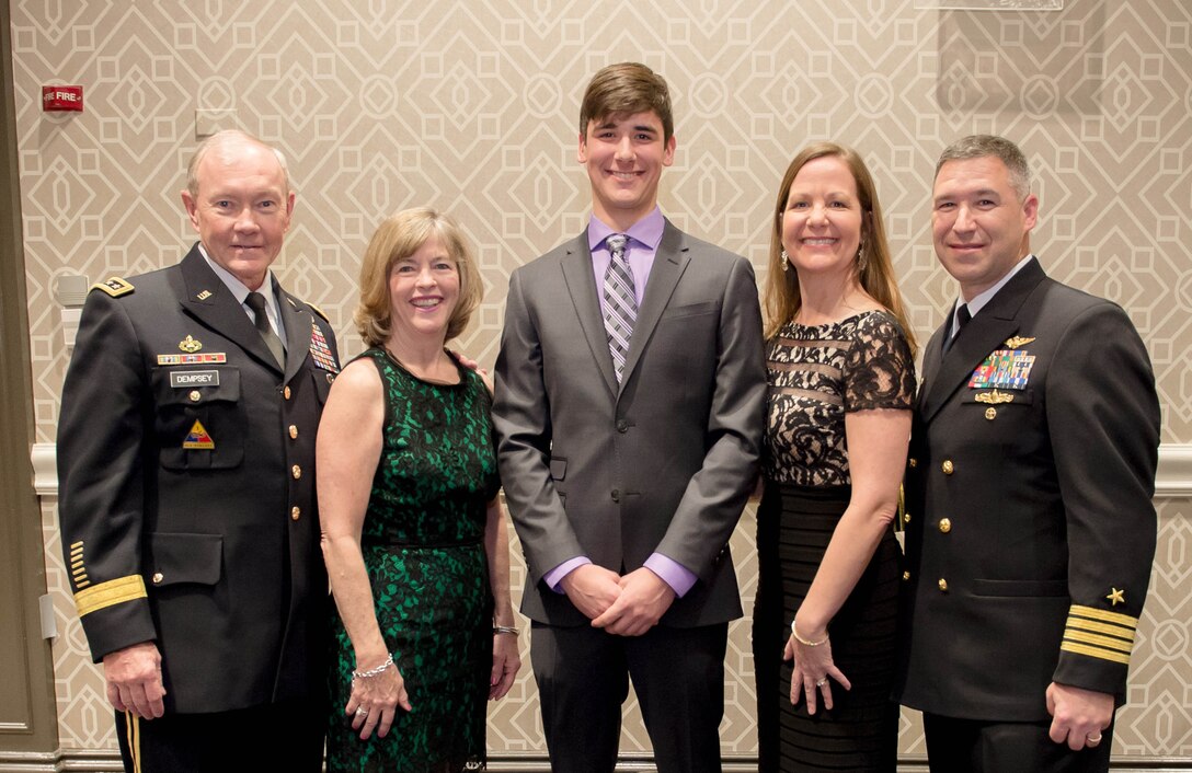 Army Gen. Martin E. Dempsey, left, chairman of the Joint Chiefs of Staff, and his wife, Deanie, pose for a photo with Ryan P. Curtin, Navy child of the year, and his family during the Operation Homefront’s 6th Annual Military Child of the Year Awards gala in Arlington, Va., April 10, 2014.