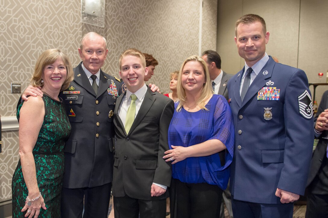 Army Gen. Martin E. Dempsey, chairman of the Joint Chiefs of Staff, and his wife, Deanie, pose for a photo with Gage A. Dabin, Air Force child of the year, and his family, during Operation Homefront’s 6th Annual Military Child of the Year Awards gala in Arlington, Va., April 10, 2014.