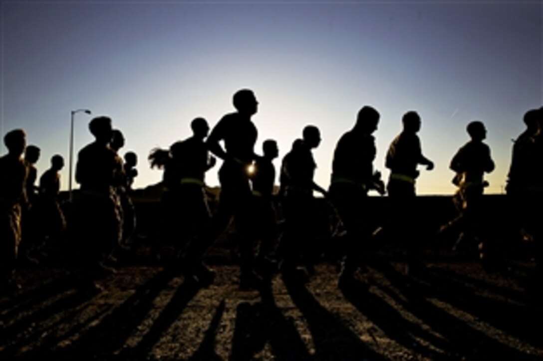 Marines participate in a three-mile training run along a fitness test track at Marine Corps Air Ground Combat Center, Twentynine Palms, Calif., April 4, 2014. The purpose of the run was to foster esprit de corps within the battalion, build unit cohesion and condition physical performance. The Marines are assigned to Headquarters Battalion.