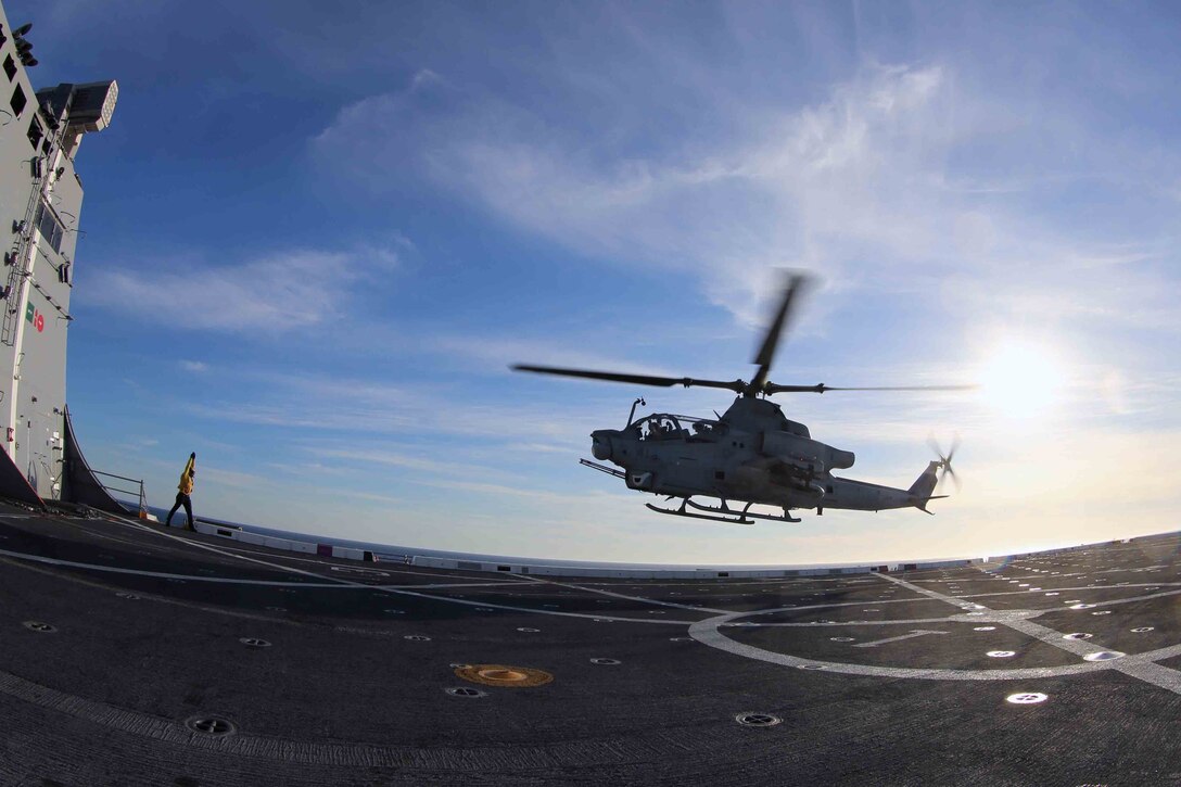 An AH-1Z Cobra leaves the flight deck of the USS San Diego as part of Amphibious Squadron Marine Expedtionary Unit Integration Training (PMINT) off the coast of San Diego, April 8, 2014. PMINT is the first at-sea event in the 11th Marine Expeditonary Unit's predeployment training program during which the unit will conduct training operations alongside the Makin Island Amphibious Ready Group. (U.S. Marine Corps photo by Cpl. Jonathan R. Waldman/RELEASED)