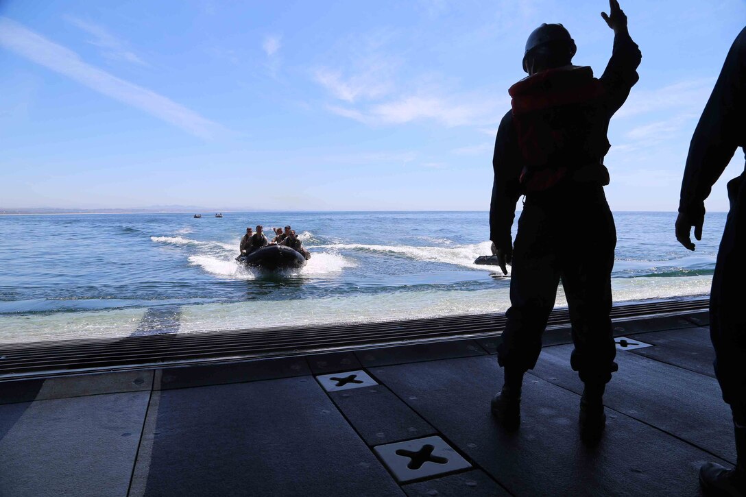 Marines with the Maritime Raid Force, 11th Marine Expeditionary Unit prepare to enter the well deck aboard the USS San Diego during Amphibious Squadron Marine Expeditionary Unit Integration Training (PMINT) off the coast of San Diego, April 8, 2014. PMINT is the first at-sea event in the 11th MEU's predeployment training program during which the unit will conduct training operations alongside the Makin Island Amphibious Ready Group. (U.S. Marine Corps photo by Cpl. Demetrius Morgan/RELEASED)