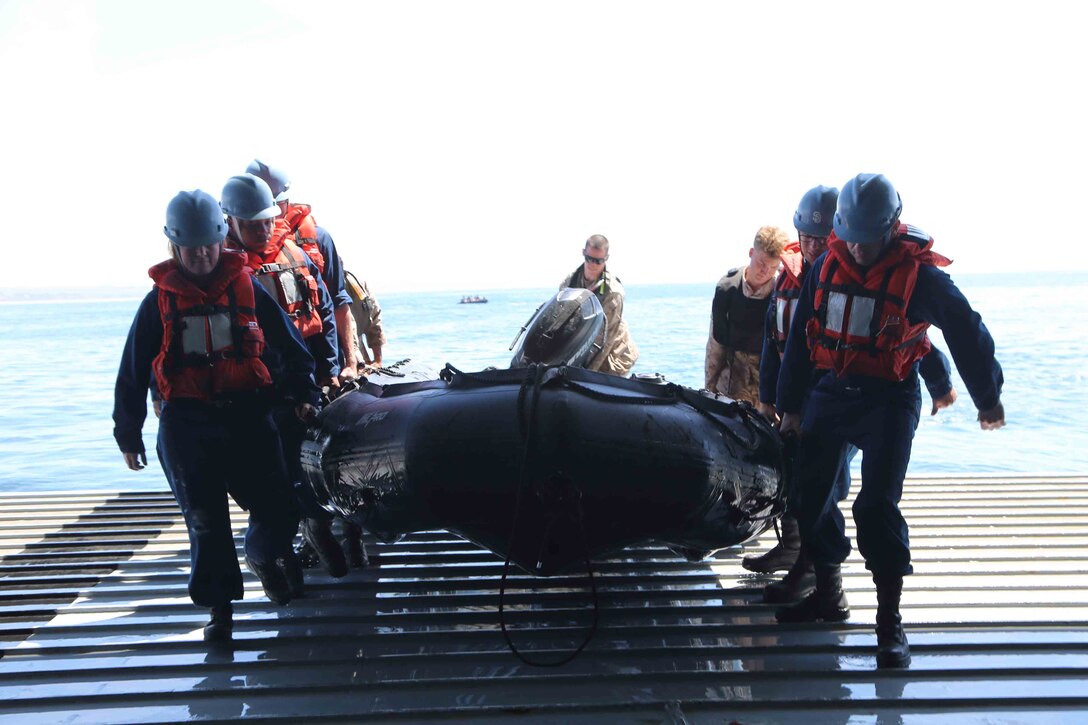Sailors aboard the USS San Diego assist the 11th Marine Expeditionary Unit’s Maritime Raid Force during a stern gate recovery as a part of Amphibious Squadron Marine Expeditionary Unit Integration Training (PMINT) off the coast of San Diego, April 8, 2014. PMINT is a two-week predeployment training event focused on the combined capabilities of the MEU and Amphibious Ready Group (ARG), conducting amphibious operations, crisis response and limited contingency operations. (U.S. Marine Corps photo by Cpl. Demetrius Morgan/RELEASED)