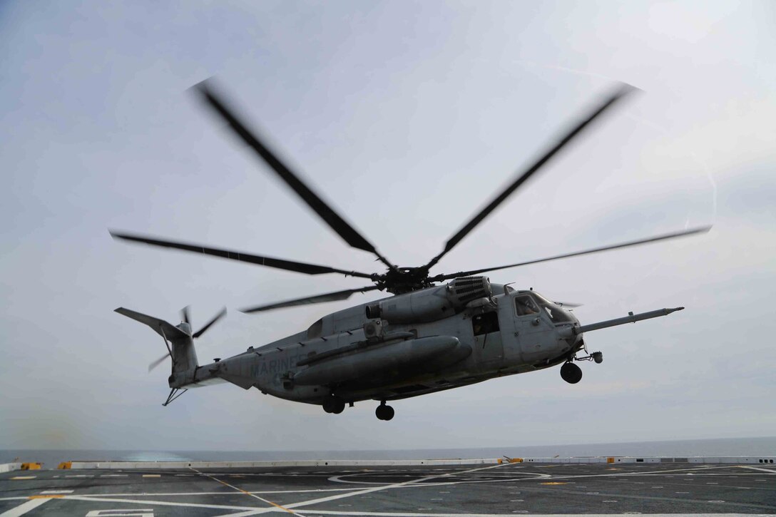 A CH-53E Super Stallion from Marine Medium Tiltrotor Squadron 163 (Reinforced), 11th Marine Expeditionary Unit, lands on the flight deck of the USS San Diego during Amphibious Squadron Marine Expeditionary Unit Integration Training (PMINT) of the coast of San Diego, April 10, 2014. PMINT is conducted by the 11th Marine Expeditionary Unit and the Makin Island Amphibious Ready Group and is the first opportunity for the MEU/ARG team to exercise its planning processes and execute live operations at sea. (U.S. Marine Corps photo by Cpl. Jonathan R. Waldman/Released)