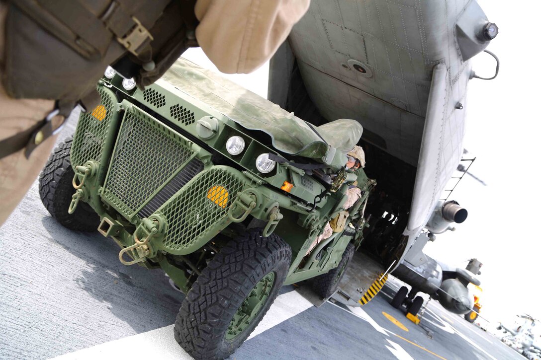 A Marine with the 1st Air Naval Gunfire Liaison Company, 11th Marine Expeditionary Unit, loads an Internally Transportable Vehicle into the fuselage of a CH-53E Super Stallion aboard the USS San Diego during Amphibious Squadron Marine Expeditionary Unit Integration Training (PMINT) off the coast of San Diego, April 10, 2014. PMINT is the first at-sea event in the 11th MEU's predeployment training program where the unit will conduct live training operations alongside the Makin Island Amphibious Ready Group. (U.S. Marine Corps photo by Cpl. Jonathan R. Waldman/Released)