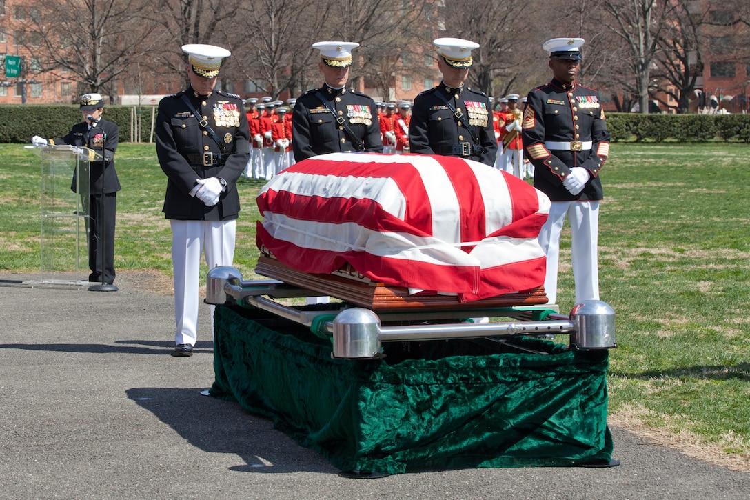 Marine Corps Commandant Gen. James F. Amos pays his respects during the military tribute to Gen. Carl Epting Mundy, Jr., the 30th Commandant of the Marine Corps, at the Marine Corps War Memorial in Arlington, Va. Amos is joined by Gen. Mundy's sons, Brig. Gen. Carl Mundy, III, and Col. Timothy Mundy, who both followed in their father's footsteps becoming commissioned officers in the United States Marine Corps.
