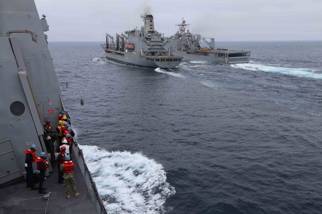 Boatswain's mates with the USS San Diego stand by as the USS Comstock is refueled by the USS Guadalupe during Amphibious Squadron Marine Expeditionary Unit Integration Training (PMINT) off the coast of San Diego, April 10, 2014. PMINT is a two-week predeployment training event focused on the combined capabilities of the MEU and Amphibious Ready Group (ARG), conducting amphibious operations, crisis response and limited contingency operations. (U.S. Marine Corps photo by Cpl. Demetrius Morgan/RELEASED)