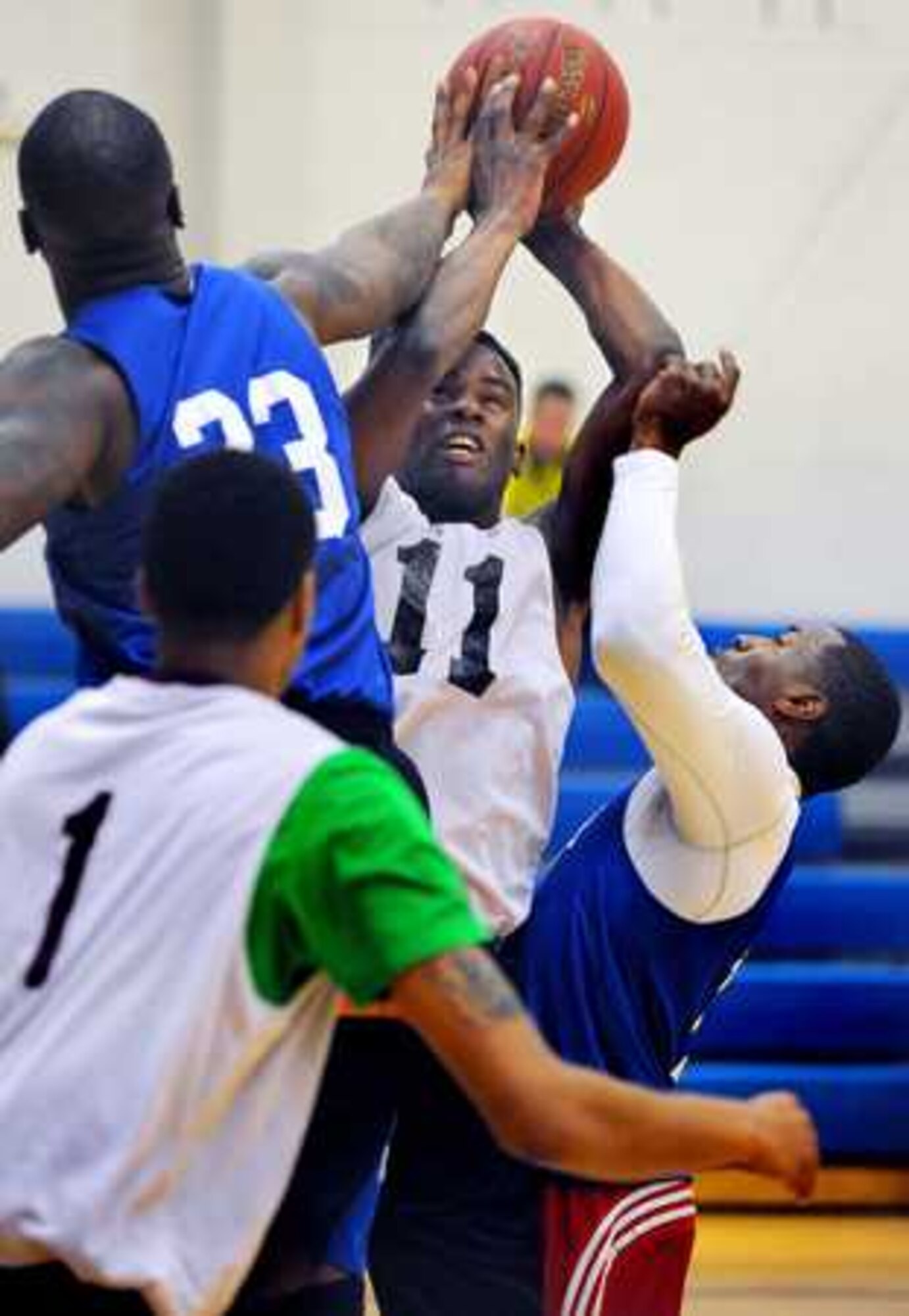 Vinan Harris has his shot blocked by 24th QM’s Shadaian Harris, left, and Kejuan Mapp during the title game at Wilson Sports and Fitness Center April 4, 2014 at Joint Base Lewis-McChord, Wash. (Northwest Guardian photo/Scott Hansen)