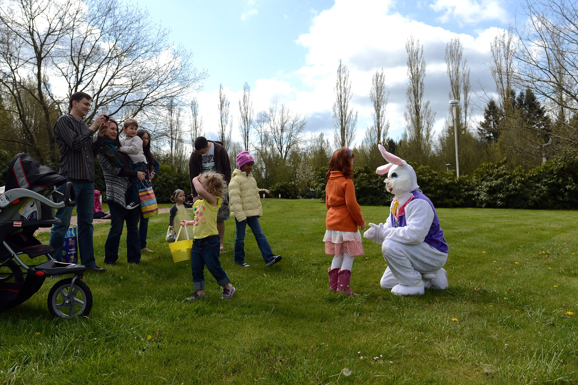 Children of Team McChord service members get their photos taken with the Easter bunny at the 5/6 Junior NCO Council’s free Easter egg hunt April 12, 2014 at Joint Base Lewis-McChord, Wash. The event was open to children of all age groups and had more than 10,000 Easter eggs, a bouncy house and Easter egg contest prizes. (U.S. Air Force photo/Airman 1st Class Jacob Jimenez)