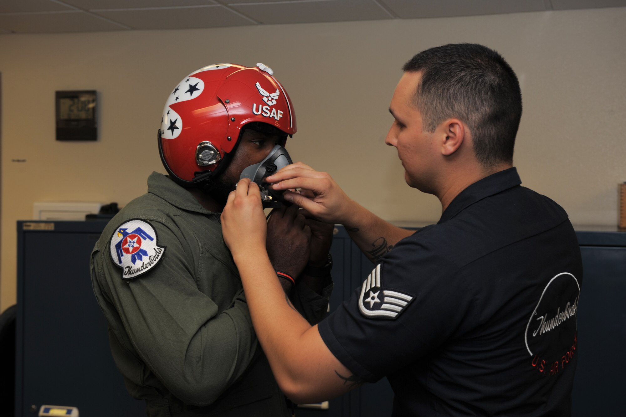 Patrick Peterson, Arizona Cardinals cornerback, gets fitted for flight gear by Staff Sgt. Jose Ibarra, U.S. Air Force Thunderbirds Air Demonstration Squadron aircrew flight equipment specialist, at Davis-Monthan Air Force Base, Ariz., April 10, 2014. Peterson is also wearing a "G Suit" intended to protect his body from the high G-force maneuvers he will experience as a passenger in the F-16 Fighting Falcon. (U.S. Air Force photo by Airman 1st Class Chris Drzazgowski/Released)