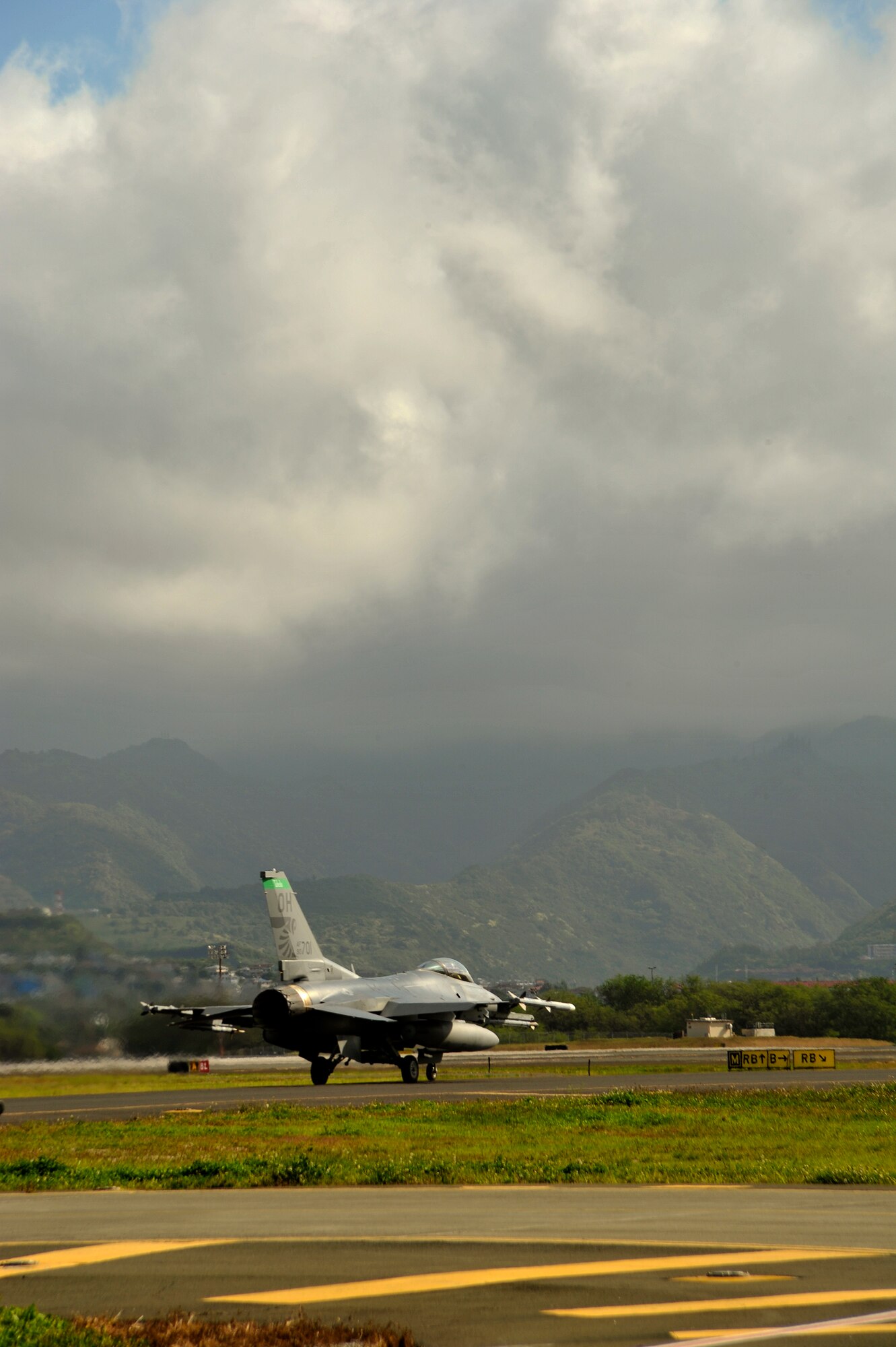 An F-16 Fighting Falcon from the 180th Fighter Wing, Ohio Air National Guard, stands ready for a morning training sortie at Hickam Air Force Base, Hawaii, March 17, 2014. The 180th Fighter Wing is participating in Sentry Aloha, a large aerial combat training exercise, with nearly 50 different airframes from the Air National Guard, Air Force Reserves and Active Duty components. Sentry Aloha allows participating units to train like they would fight in combat, focusing on offensive and defensive counter air measures and fighter integration. Air National Guard photo by Master Sgt. Beth Holliker (Released). 
