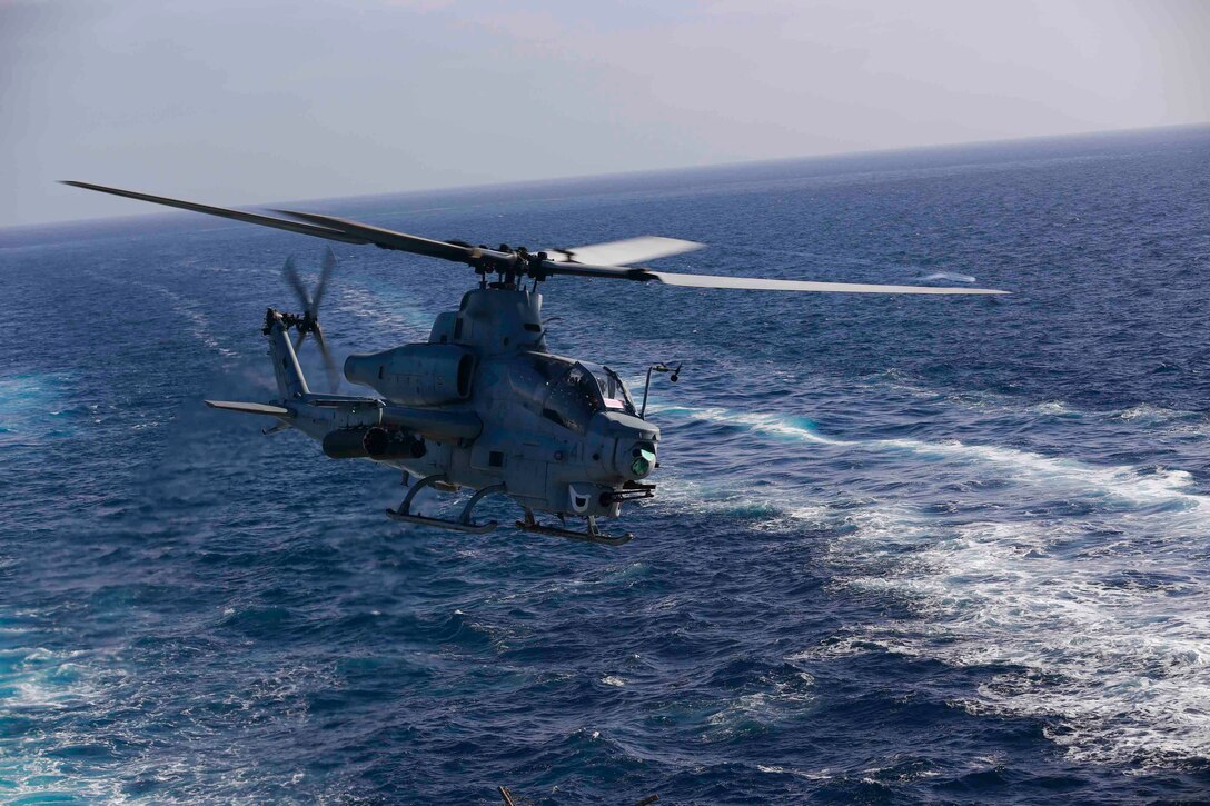 An AH-1Z Cobra from Marine Medium Tiltrotor Squadron 163 (Reinforced), 11th Marine Expeditionary Unit, flies over the USS San Diego as part of Amphibious Squadron Marine Expeditionary Unit Integration Training (PMINT) off the coast of San Diego, April 11, 2014. PMINT is the first at-sea event in the 11th MEU's predeployment training program during which the unit will conduct sea-based training operations alongside the Makin Island Amphibious Ready Group. (U.S. Marine Corps photo by Gunnery Sgt. Jimmy H. Bention, Jr./RELEASED)