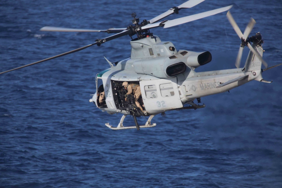 A UH-1Y Huey with Marine Medium Tiltrotor Squadron 163 (Reinforced), 11th Marine Expeditionary Unit, supports a visit, board, search and seizure training mission during Amphibious Squadron Marine Expeditionary Unit Integration Training (PMINT) off the coast of San Diego, April 11, 2014. PMINT is the first at-sea event in the 11th MEU's predeployment training program where the unit will conduct training operations alongside the Makin Island Amphibious Ready Group. (U.S. Marine Corps photo by Cpl. Jonathan R. Waldman/RELEASED)